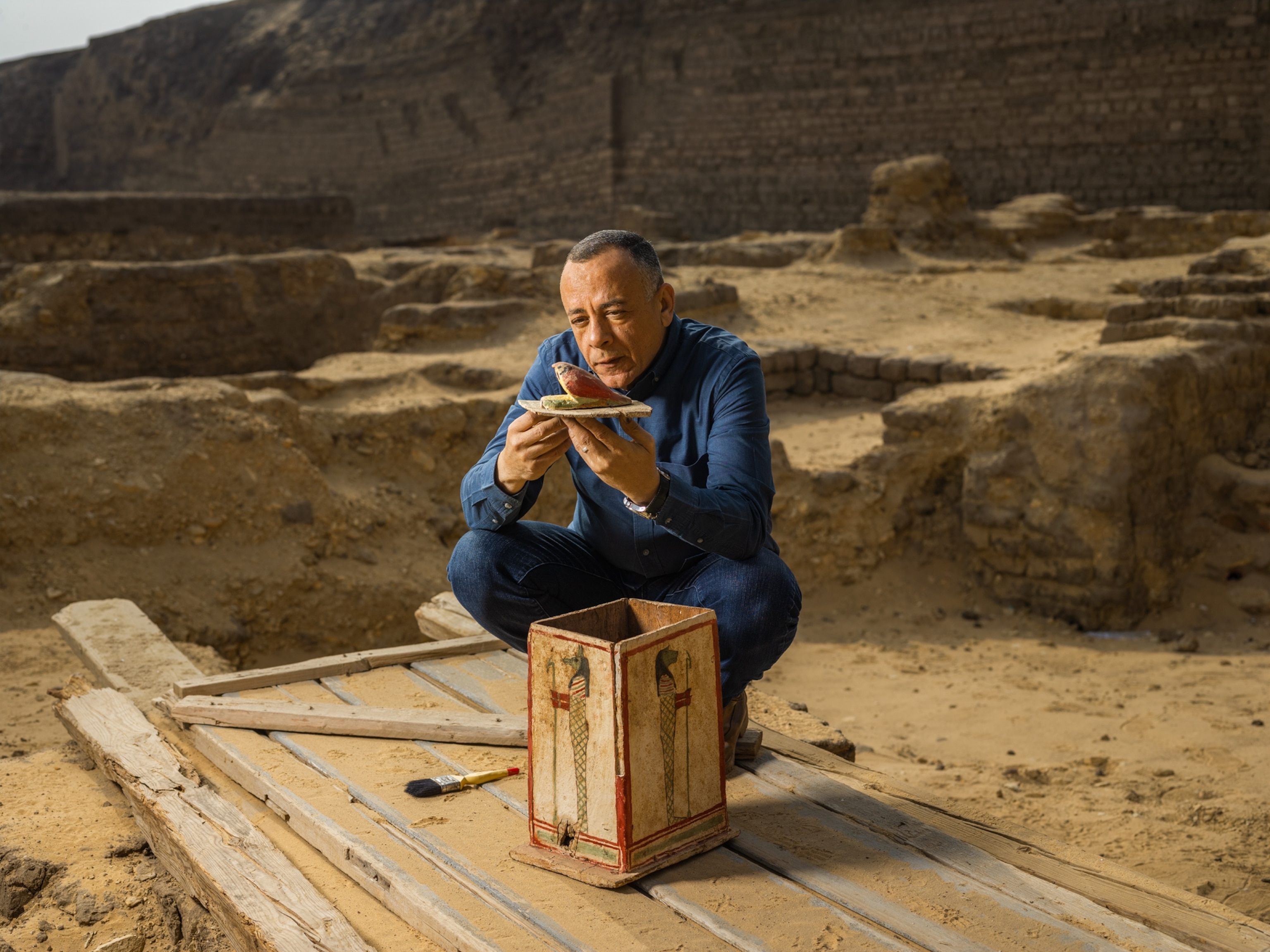 An archeologist holds an antique.