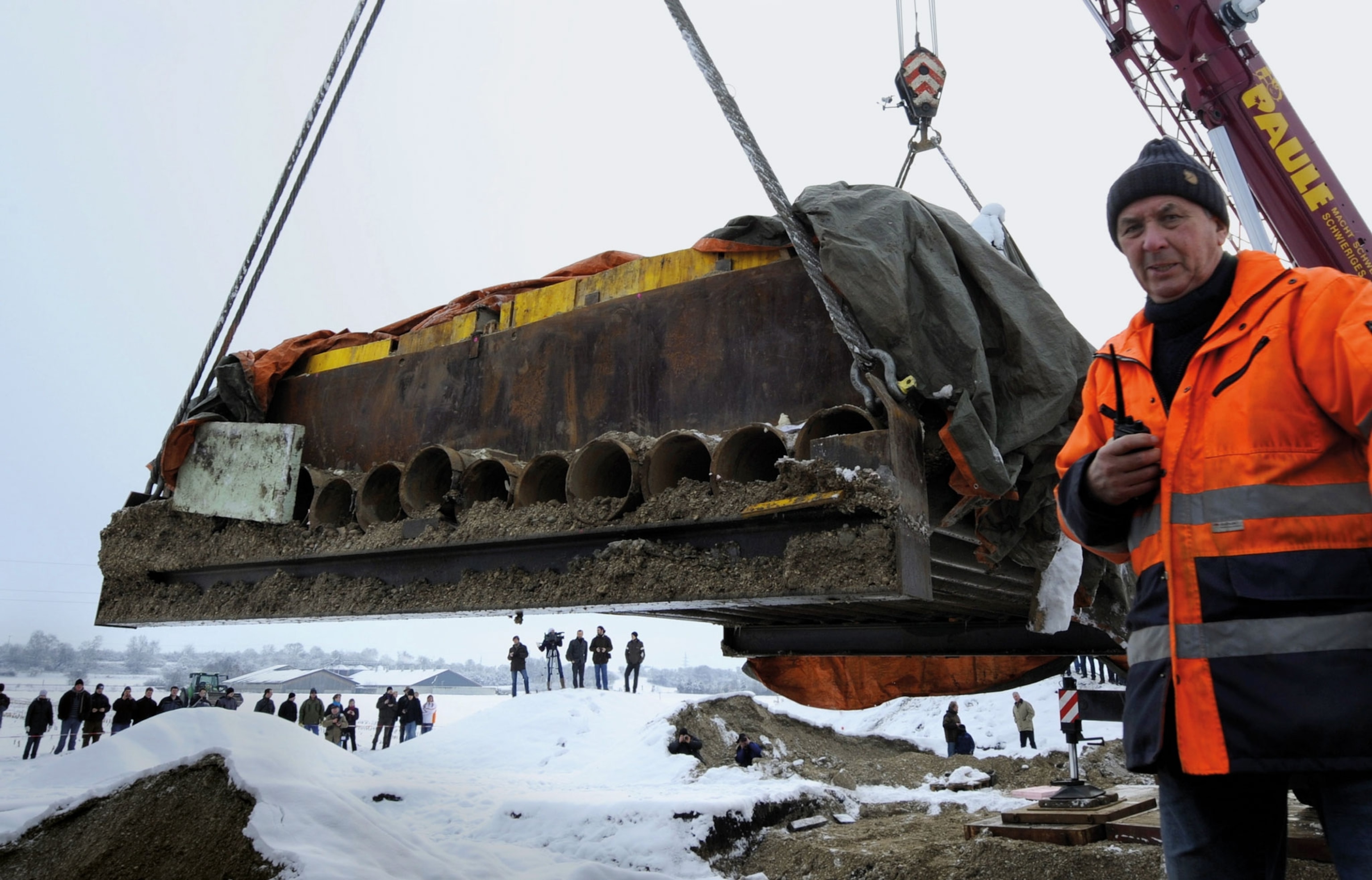 A large platform is raised by a crane