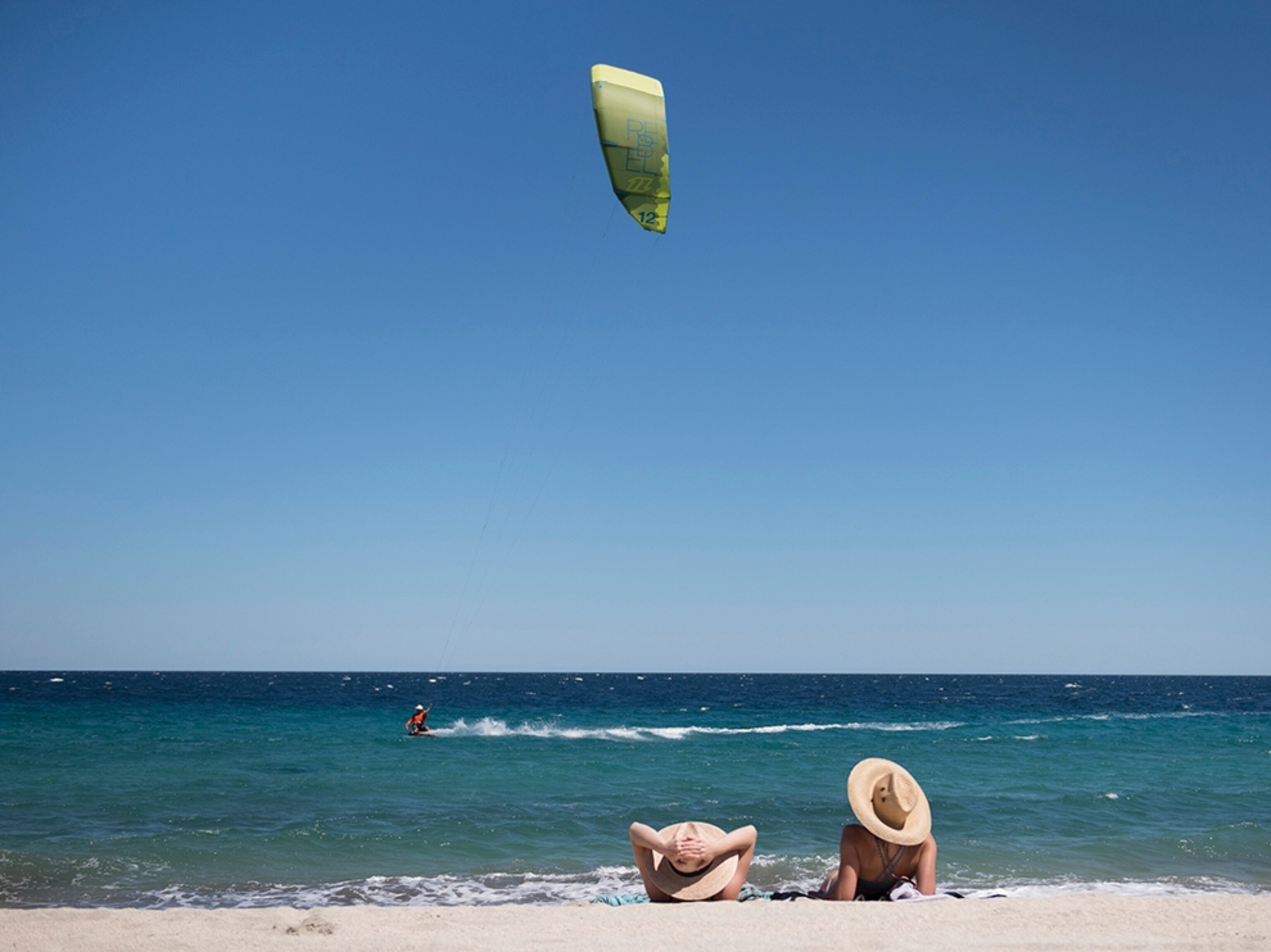 two women sitting on the beach in Los Barilles, Baja, Mexico