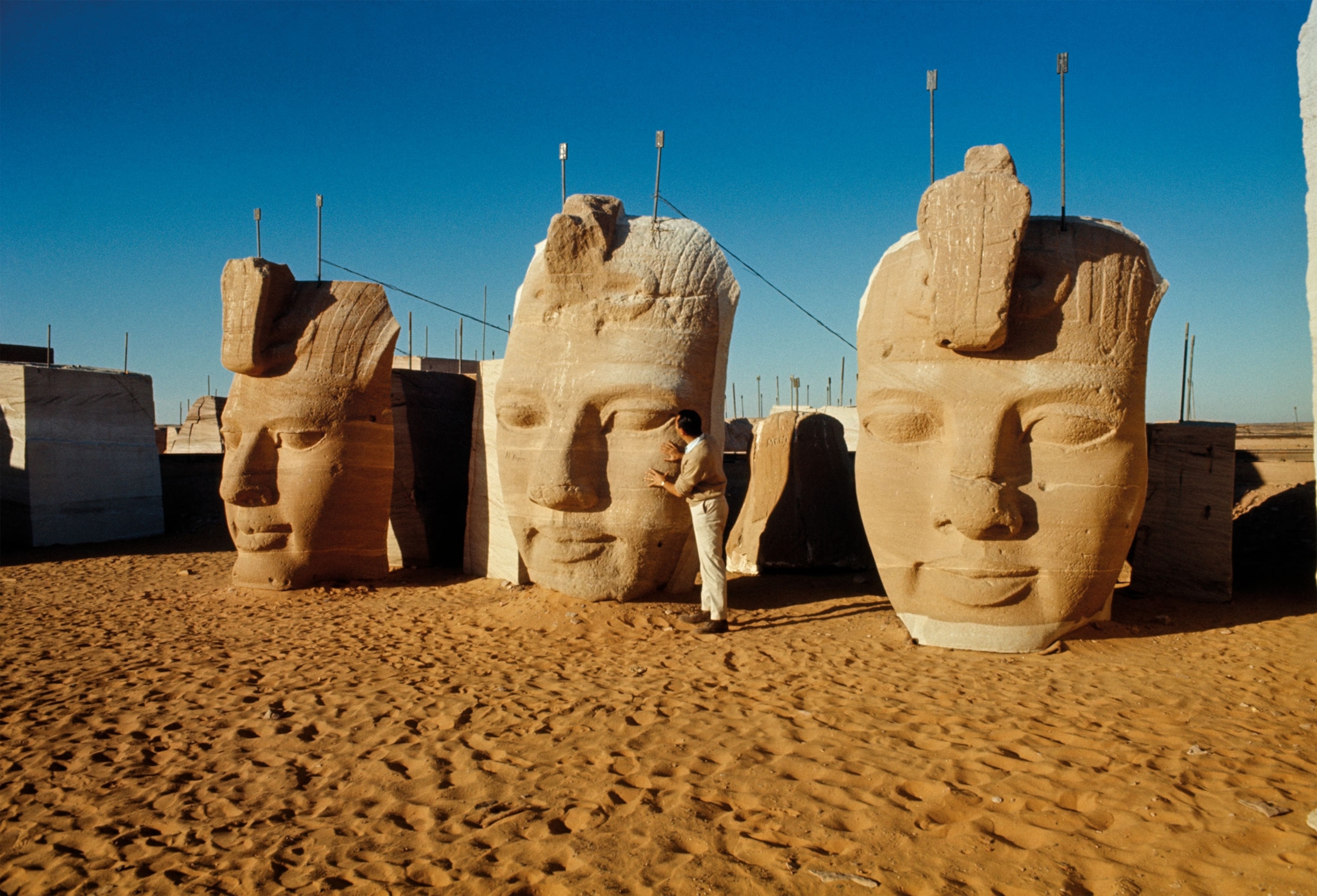 faces of three of four colossal statues at the entrance to the Great Temple of Ramses II