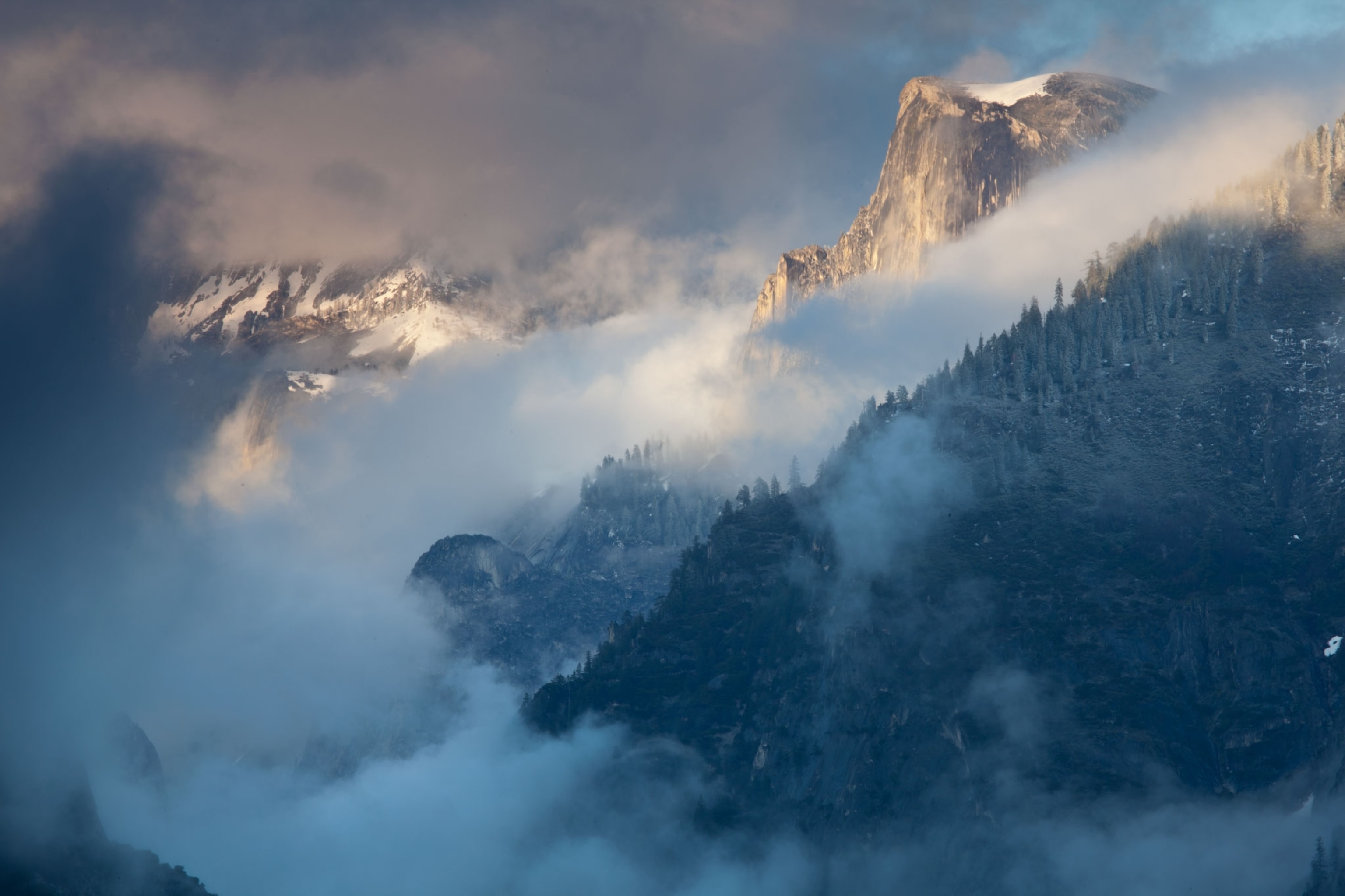 Half Dome enveloped by clouds