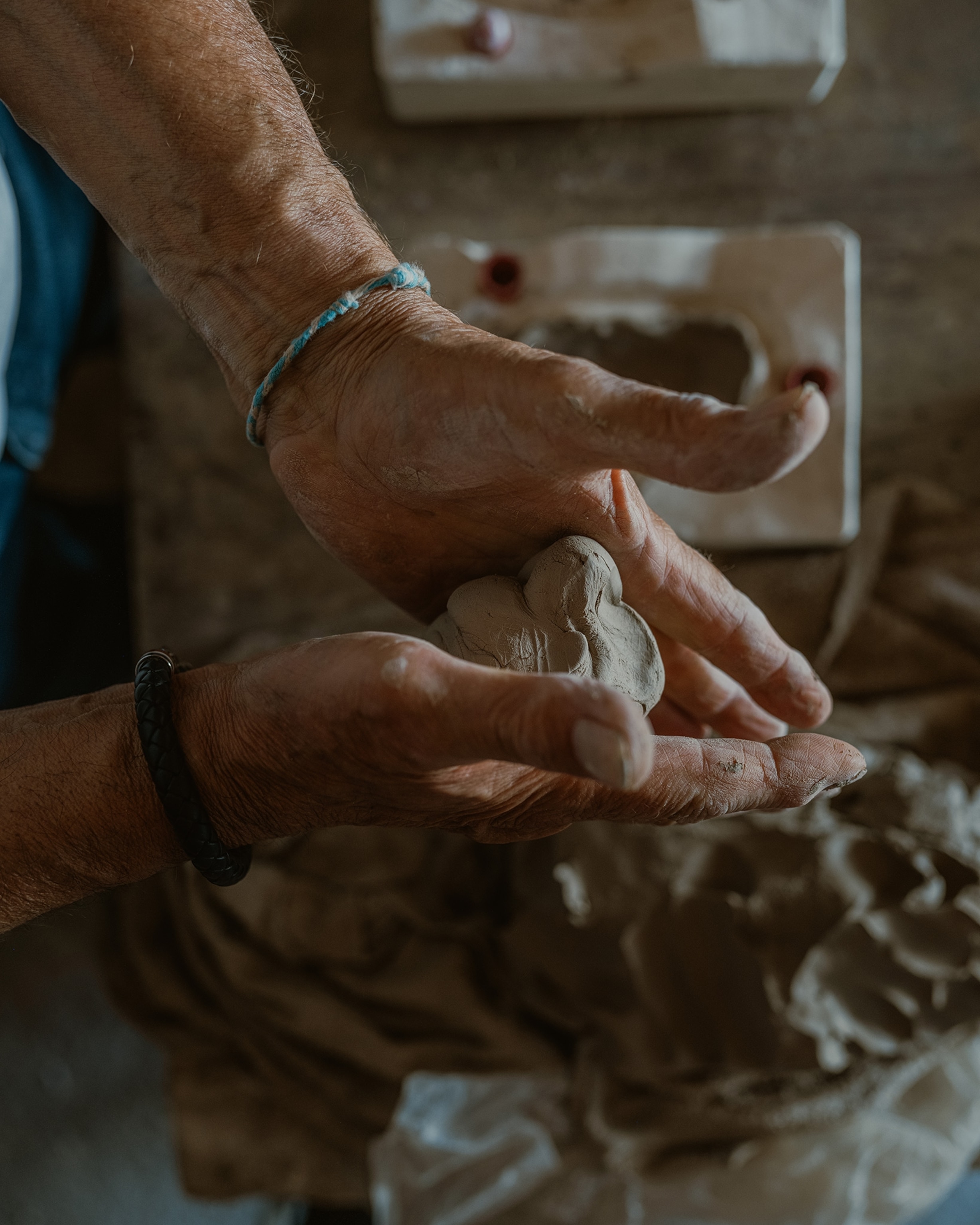 Bernard Amy rolls clay in his hands.