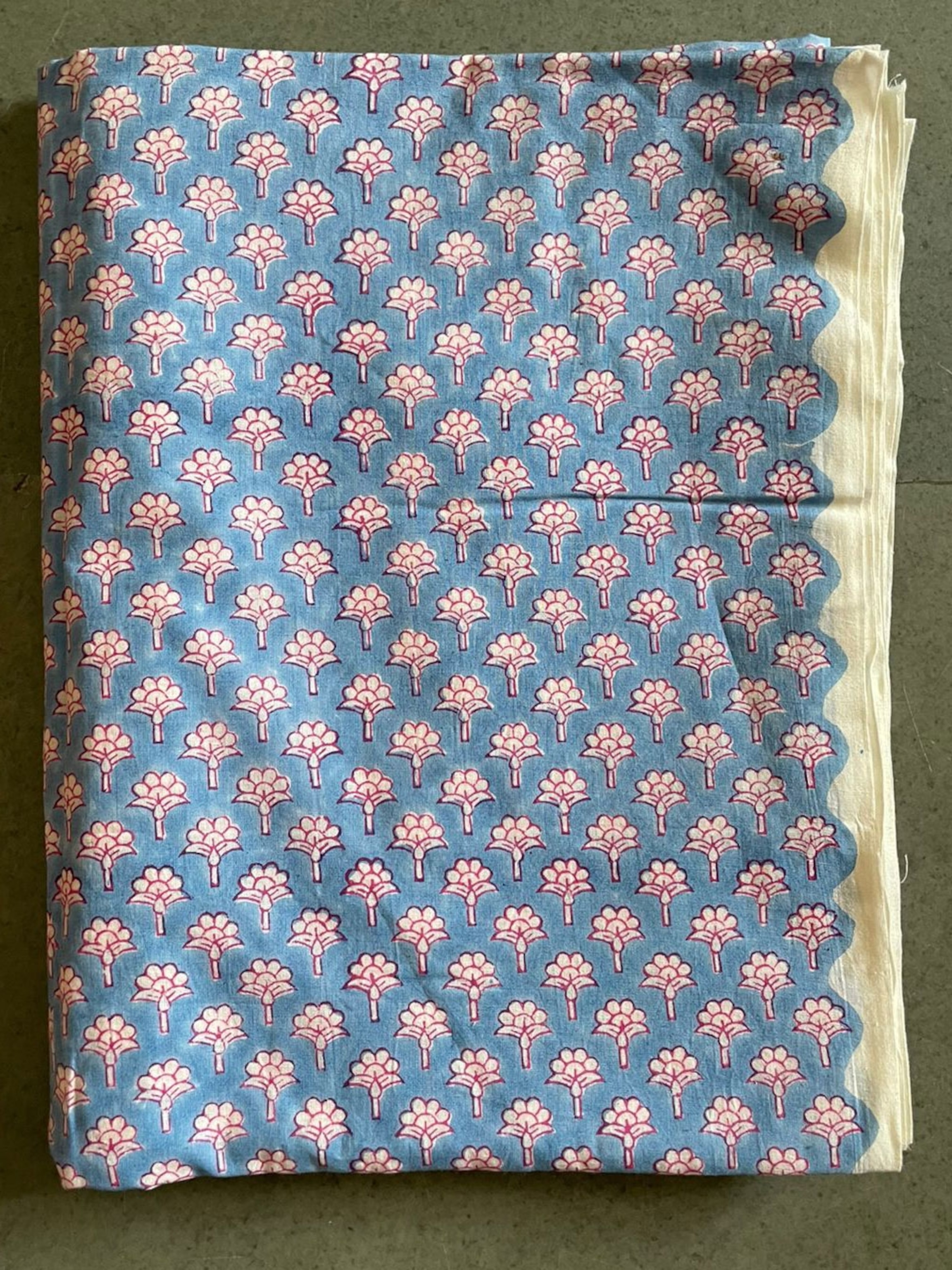 a blue fabric with hand block prints