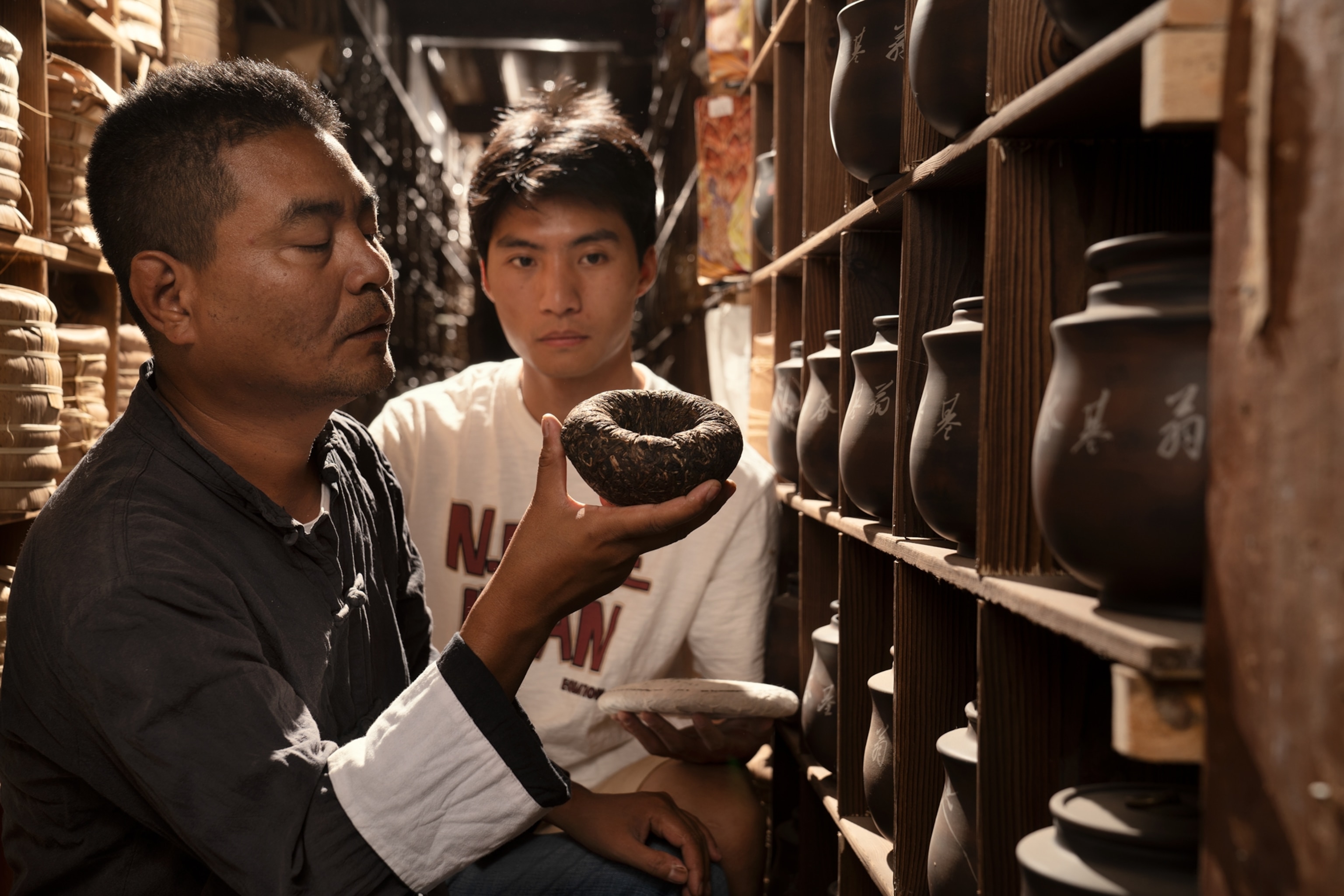 Two men look at a tea cake.