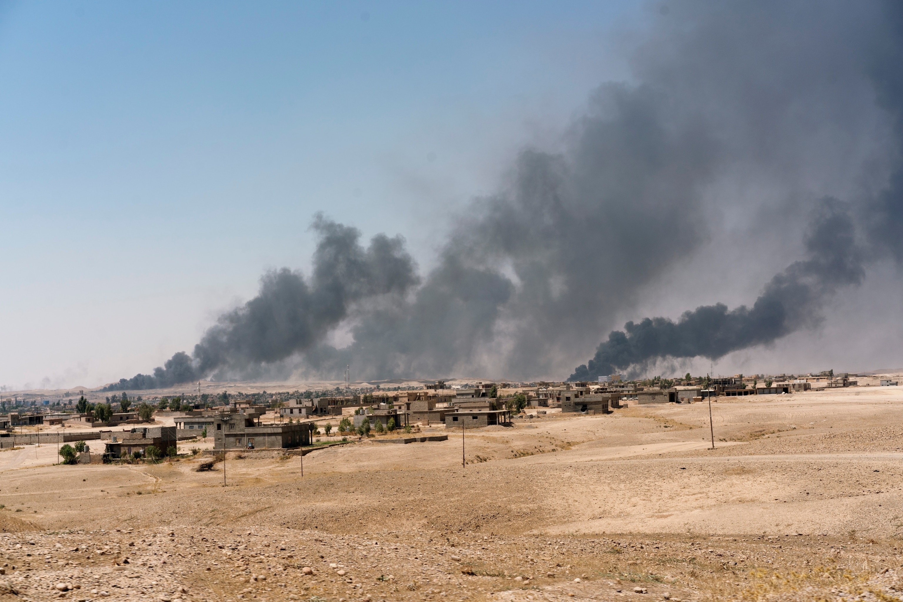 smoke rising from Qayarah oilfields