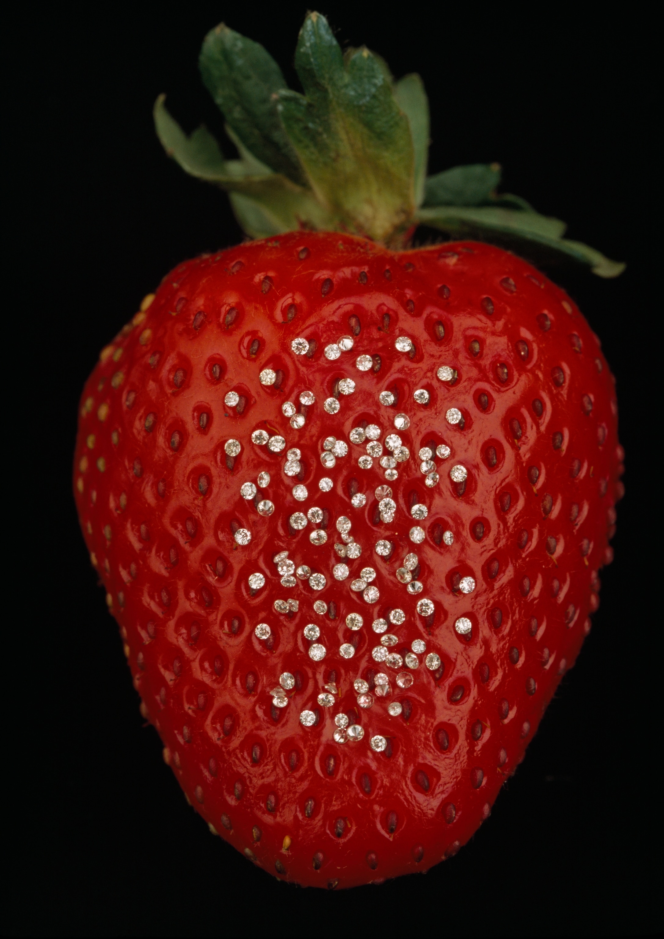 small diamonds in the holes of a strawberry's seed-studded areas