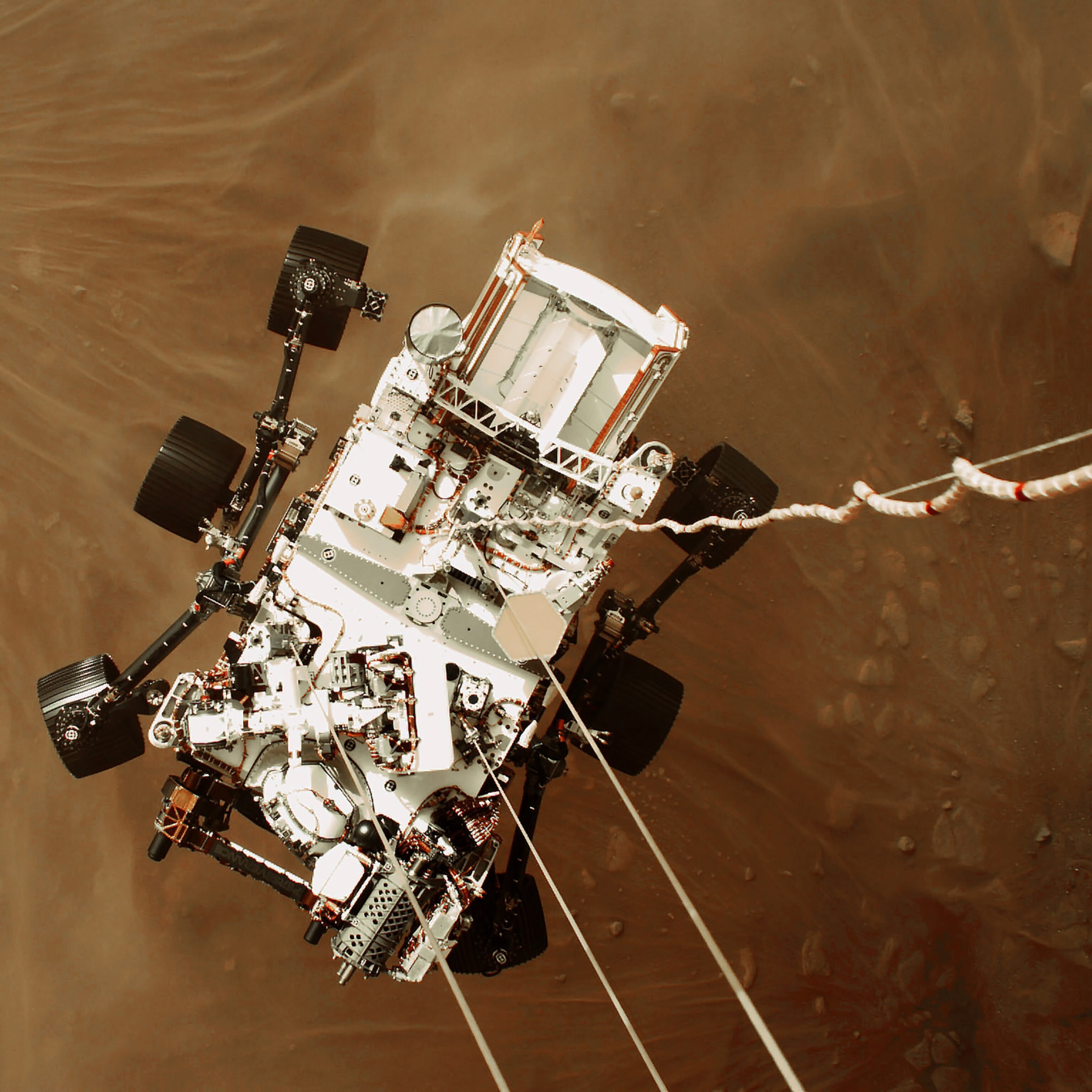 Picture of rover suspended above ground on cables.