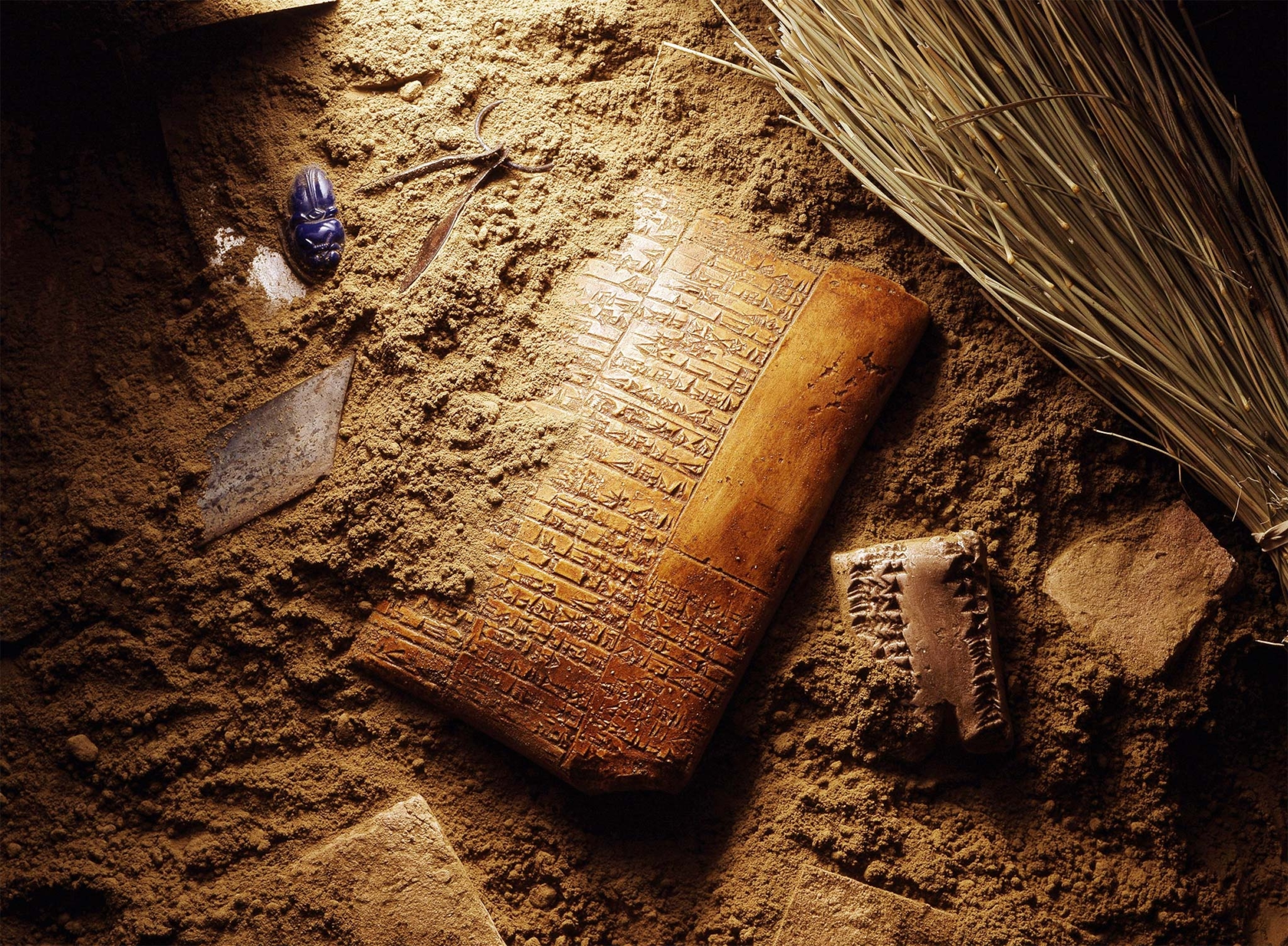 A circa 2400 B.C. Sumerian cuneiform tablet partially buried in sand is inscribed with medical prescriptions.