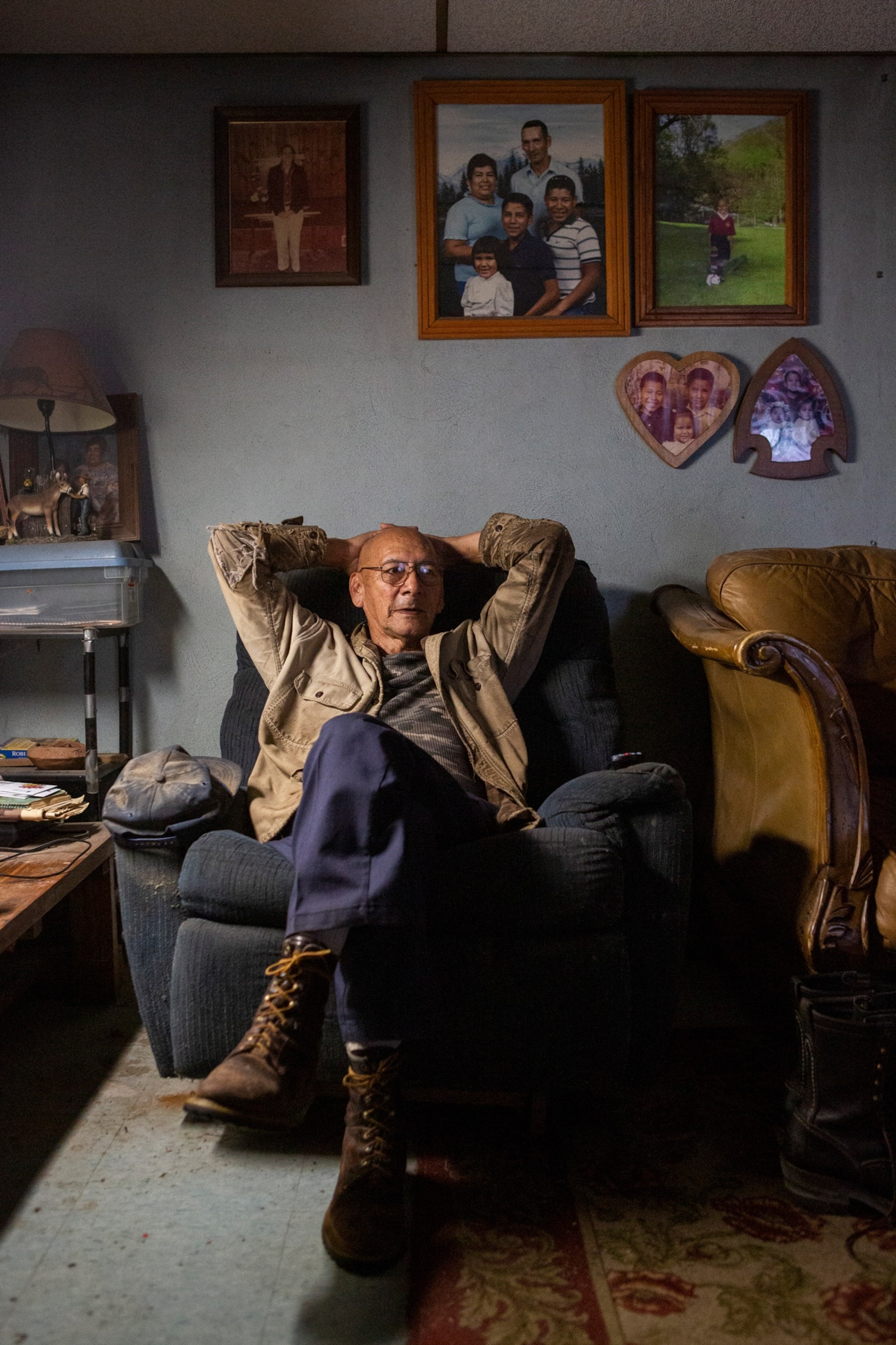 A man reclines on a loveseat