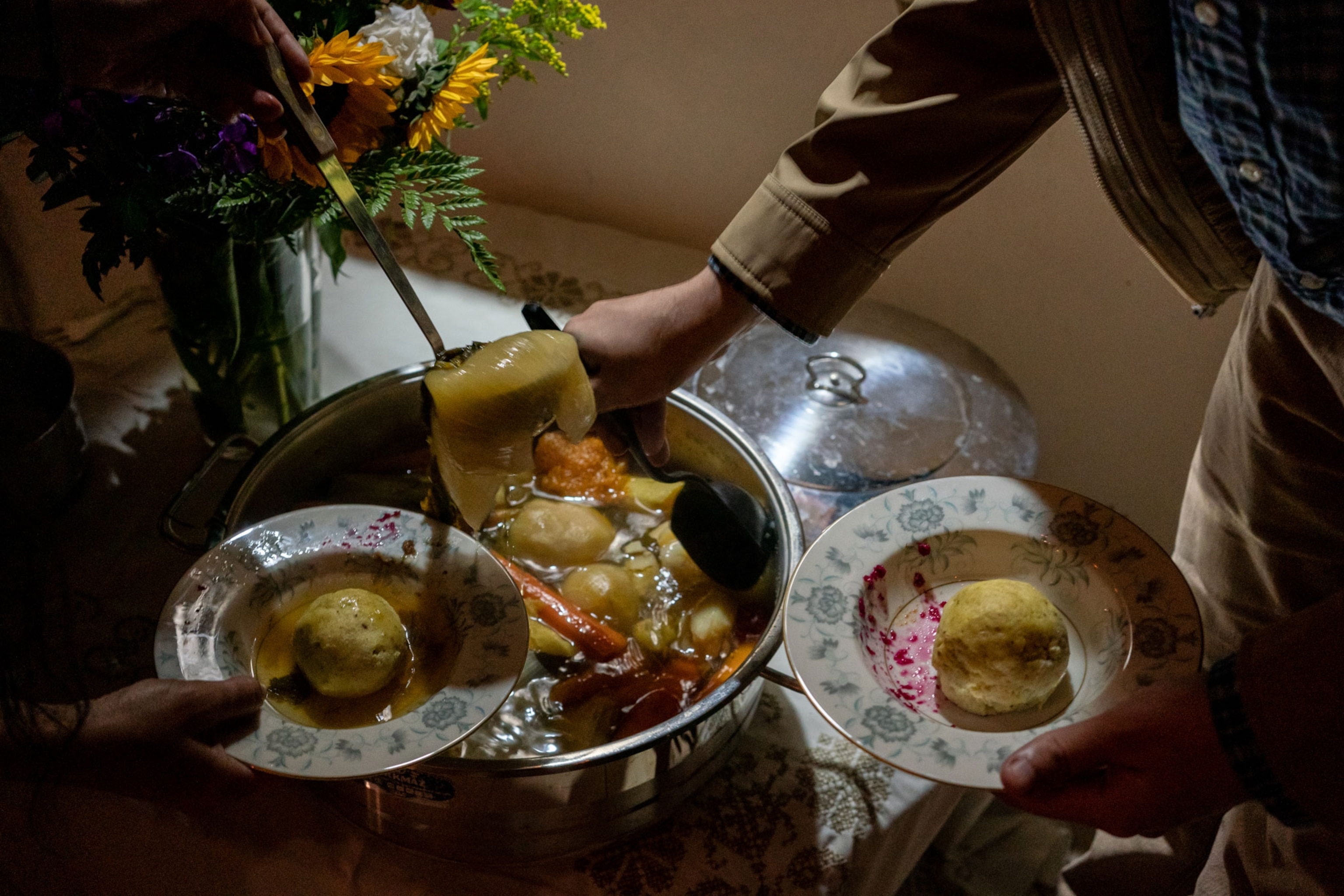people dishing soup