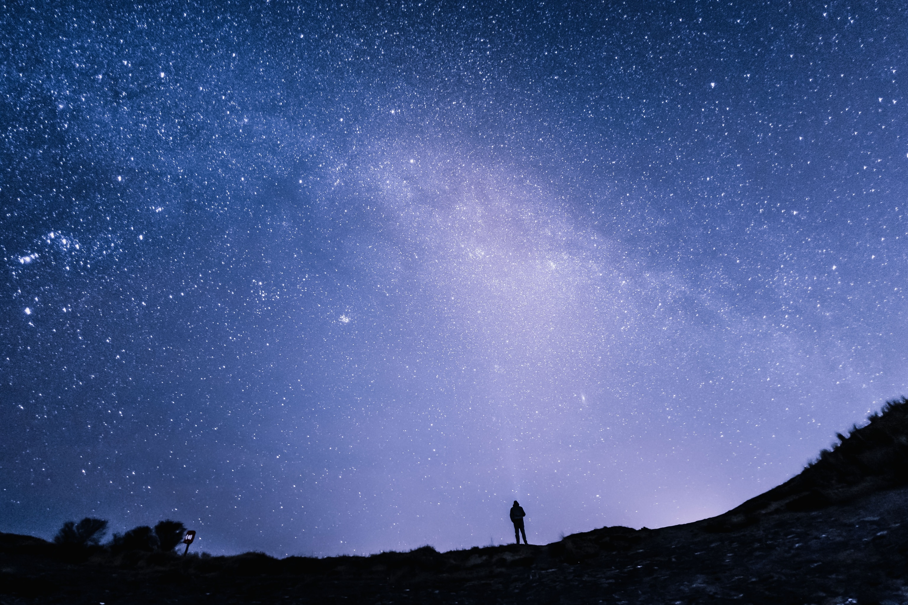 man staring up at starry sky