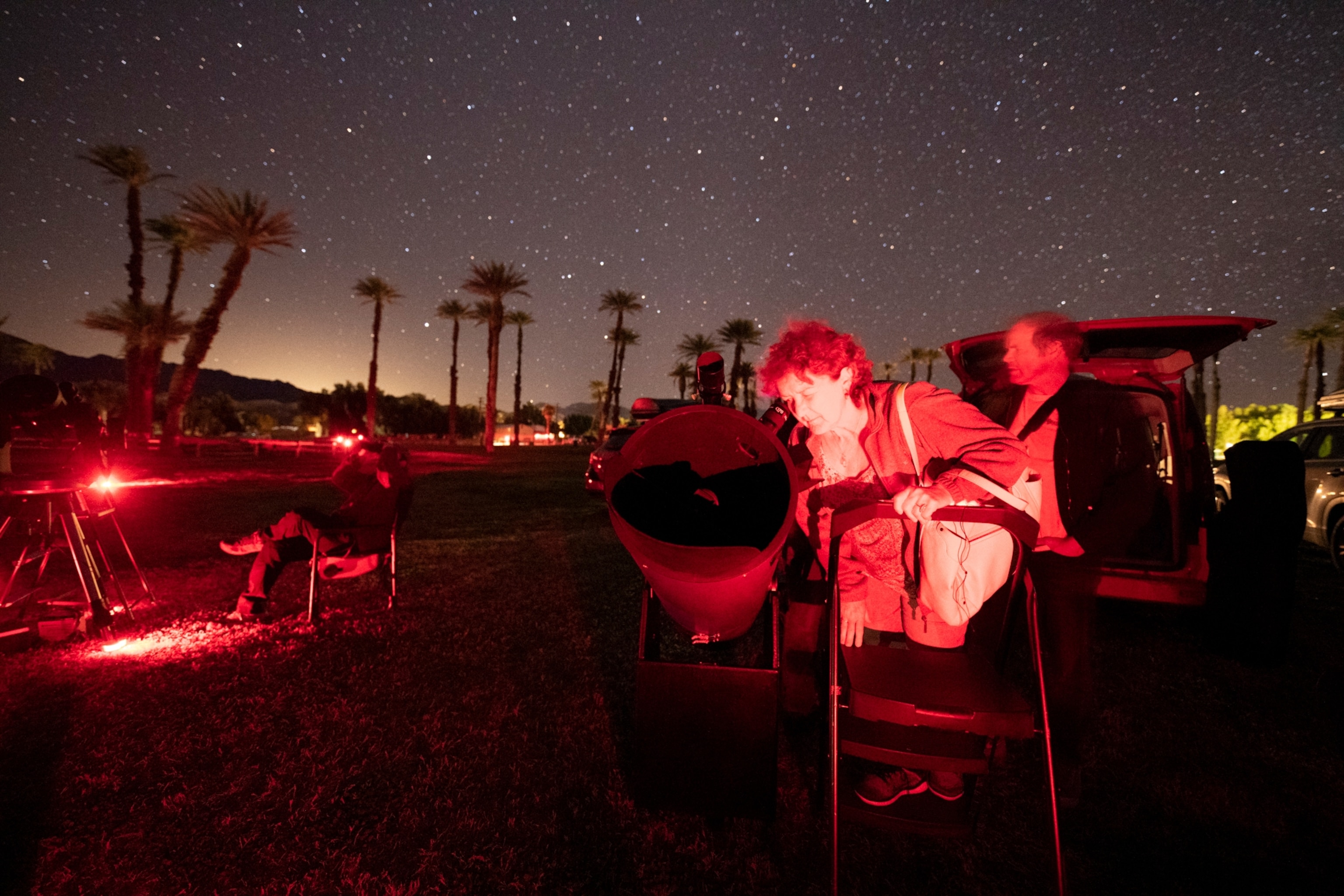 a woman looking into a telescope