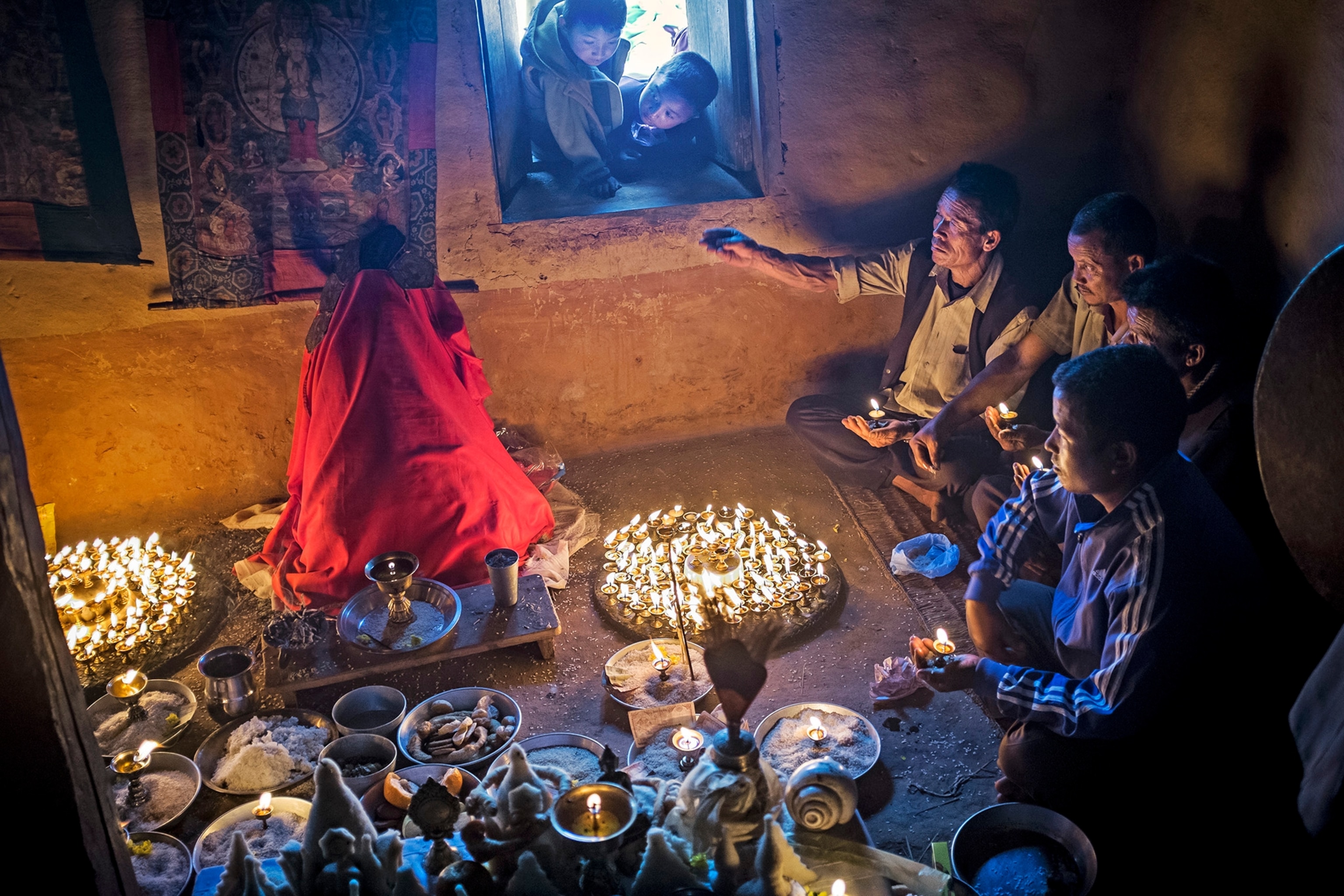 a family gathered around covered dead body