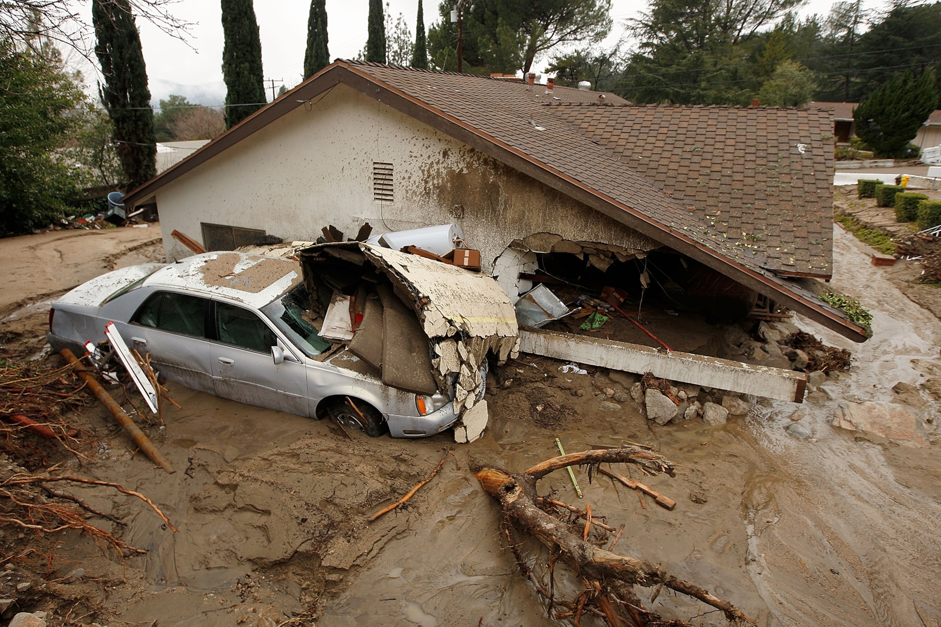 A debris flow damages a home after heavy rains caused mudslides February 6, 2010 in La Canada Flintridge, California.
