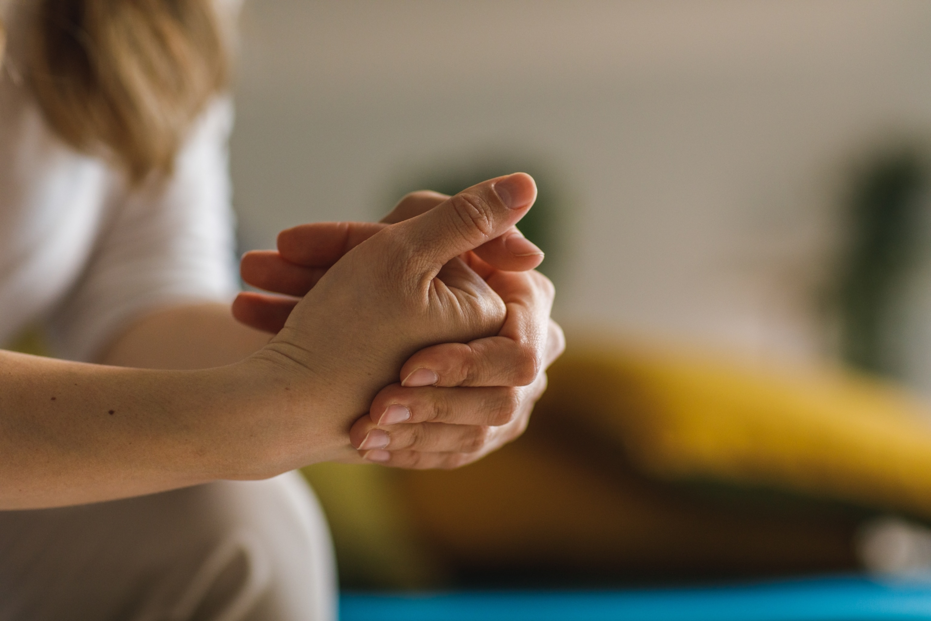 A close-up view of a woman cracking her knuckles.