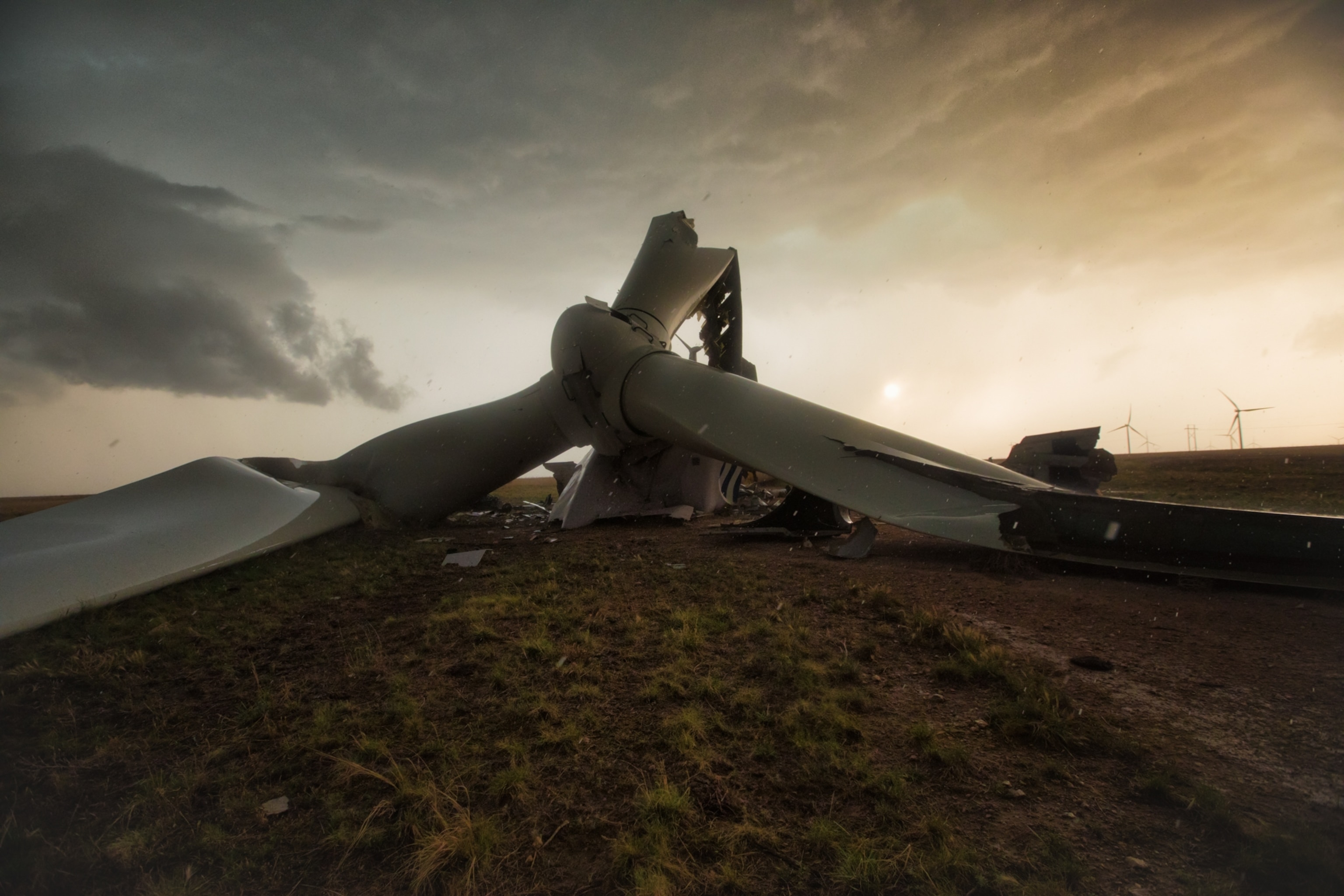 The crumpled and bent frame and propellers of a wind turbine that was damaged by a tornado.