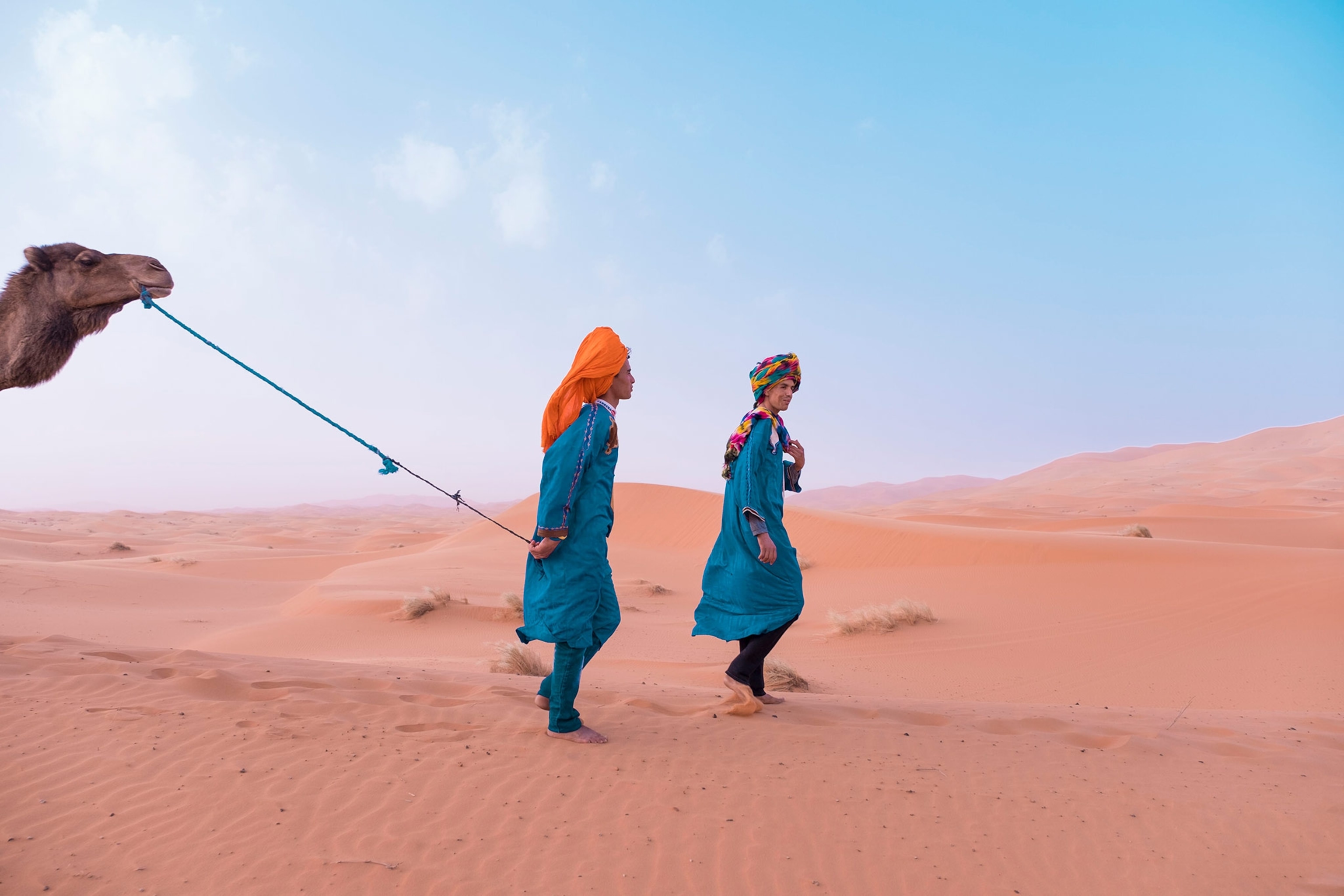 camels and handlers in Merzouga, Meknes-Tafilalet, Morocco