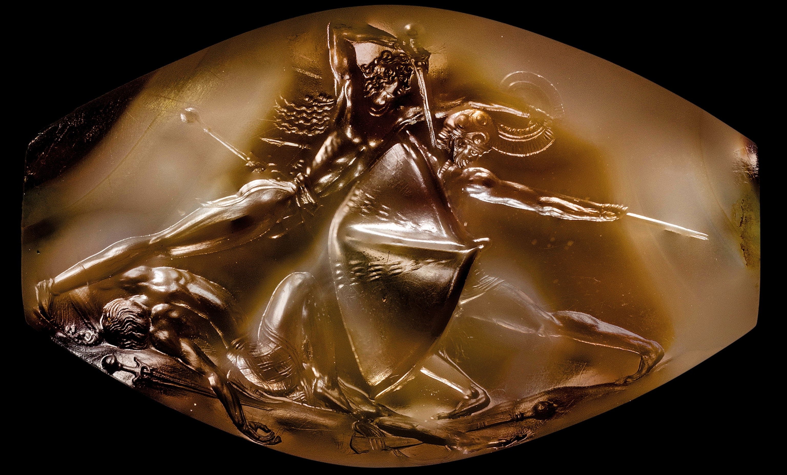 Found among the Griffin Warrior’s many grave goods, the Combat Agate depicts a scene among three warriors. Two are locked in deadly combat and one has fallen to the ground.