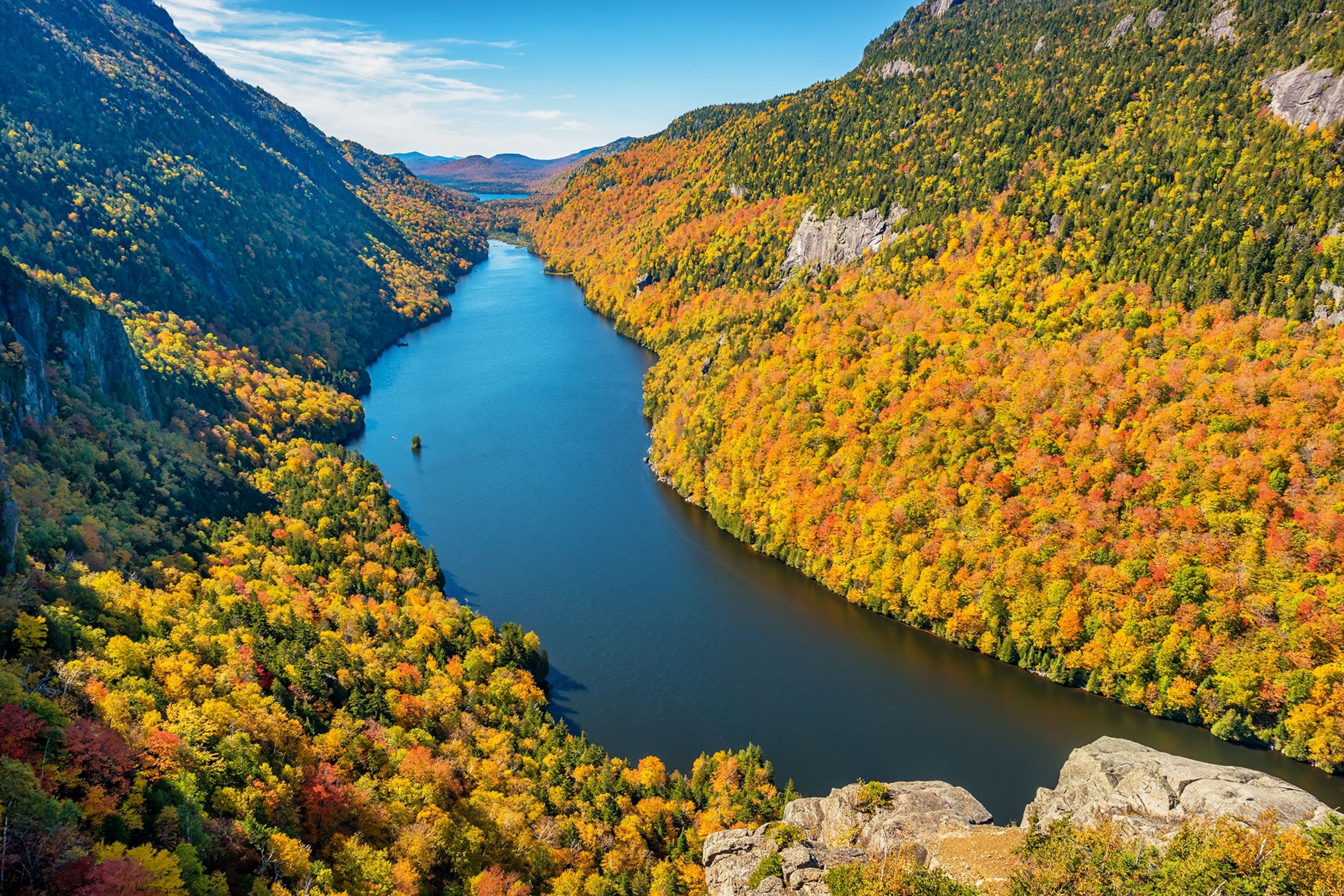 A valley in America with an array of yellow, green and red leaved trees.