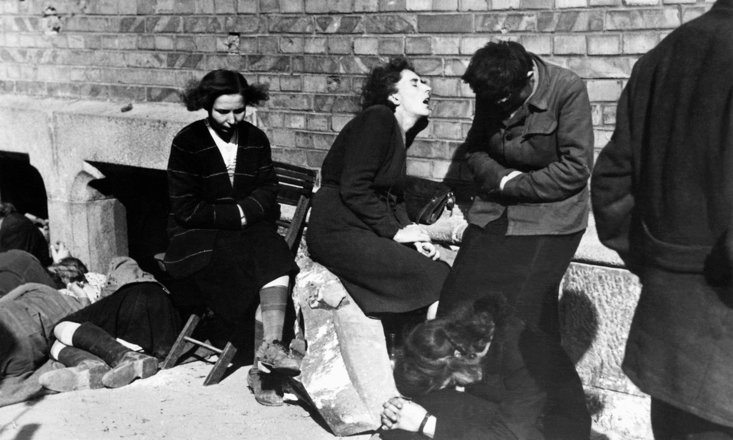 a woman in desperation surrounded by other struggling people on the street