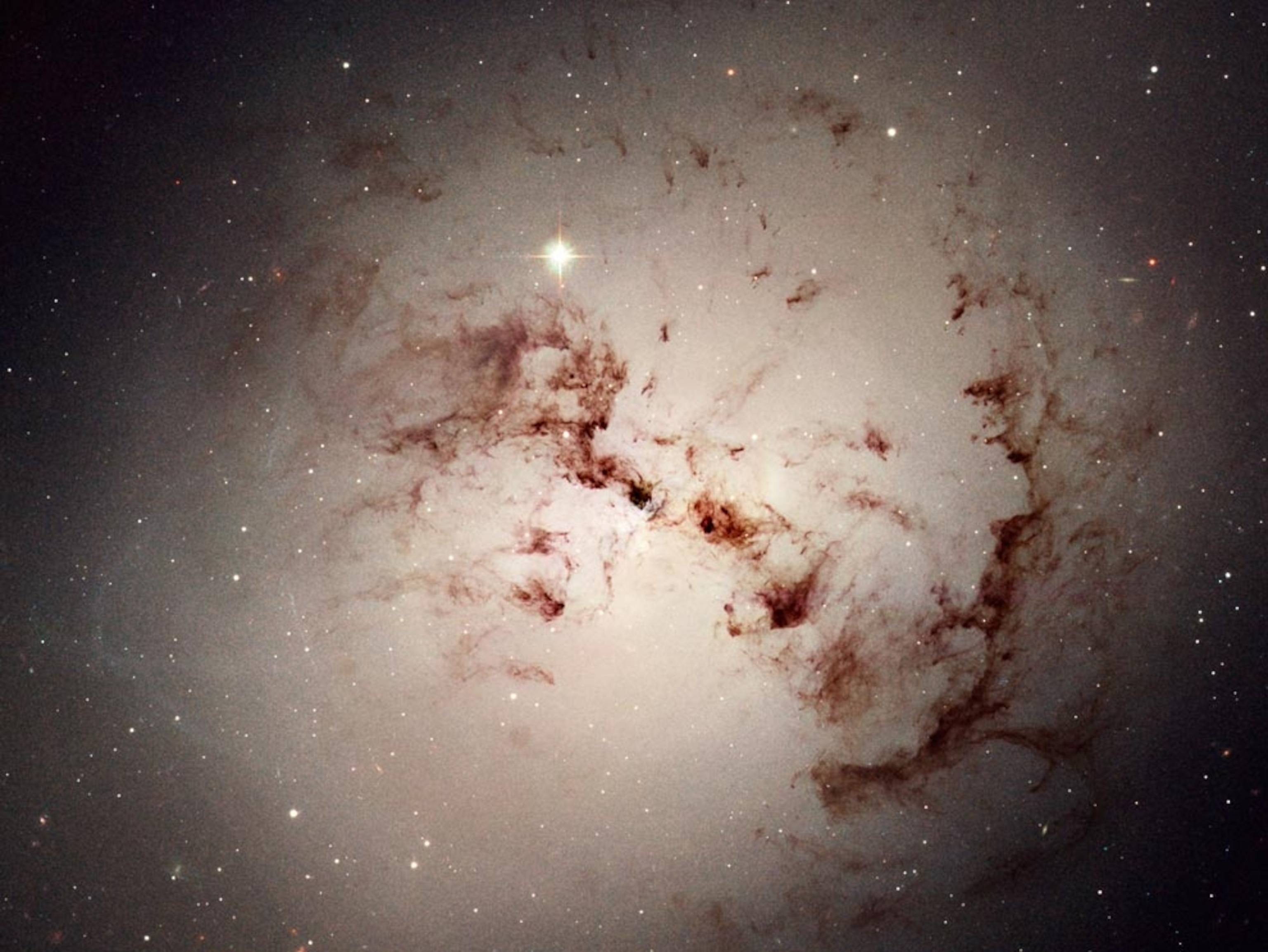 Elliptical galaxy and billowing cosmic dust