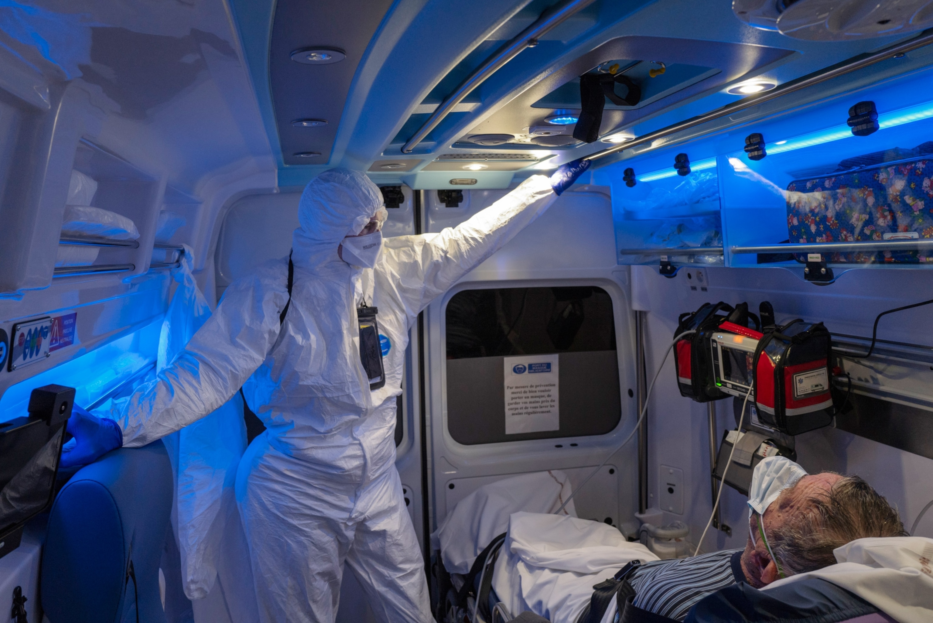 an medical professional attending to a man in an ambulance