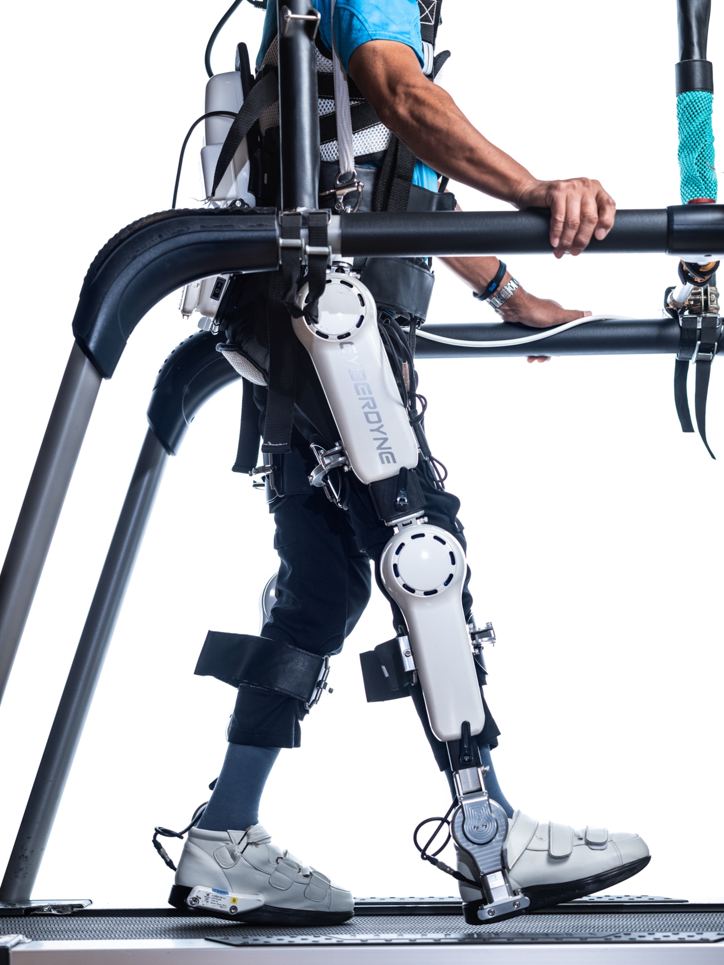 a mechanical device encompassing a leg as a person walks on a treadmill