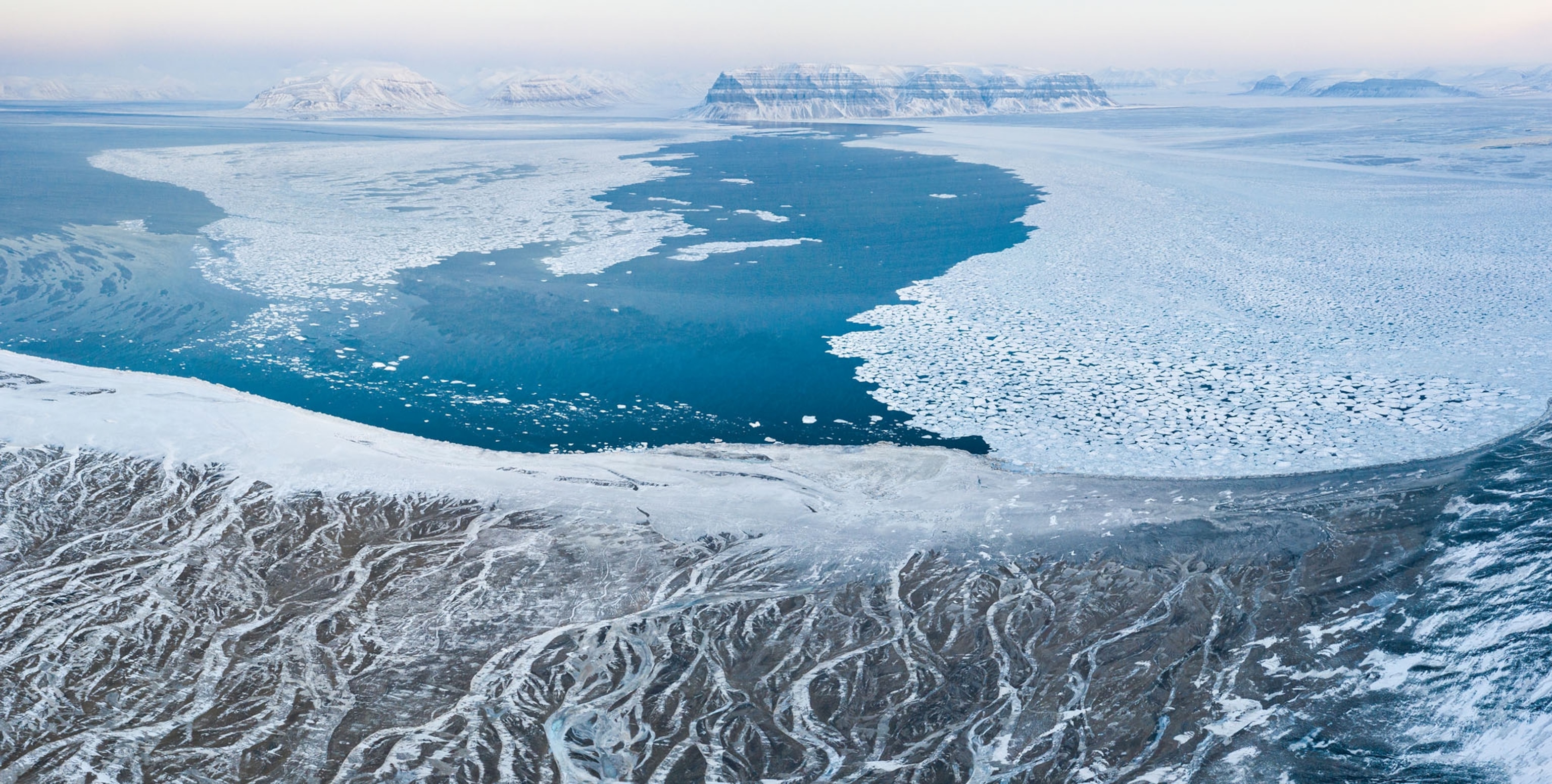 Picture of aerial view of Elveneset and the Bay of Sassenfjorden with white snow on blue ice.
