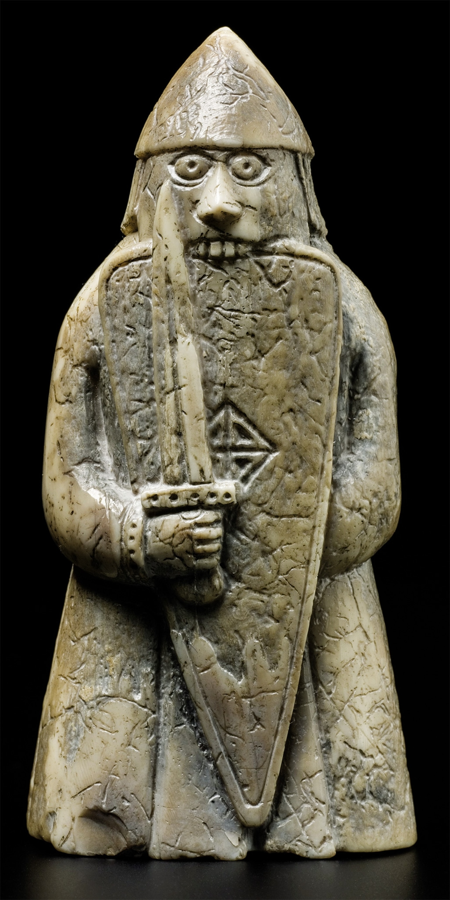 A Viking warrior biting his shield is a chess piece from a 12th-century set was found on the Isle of Lewis, Scotland, in 1831.