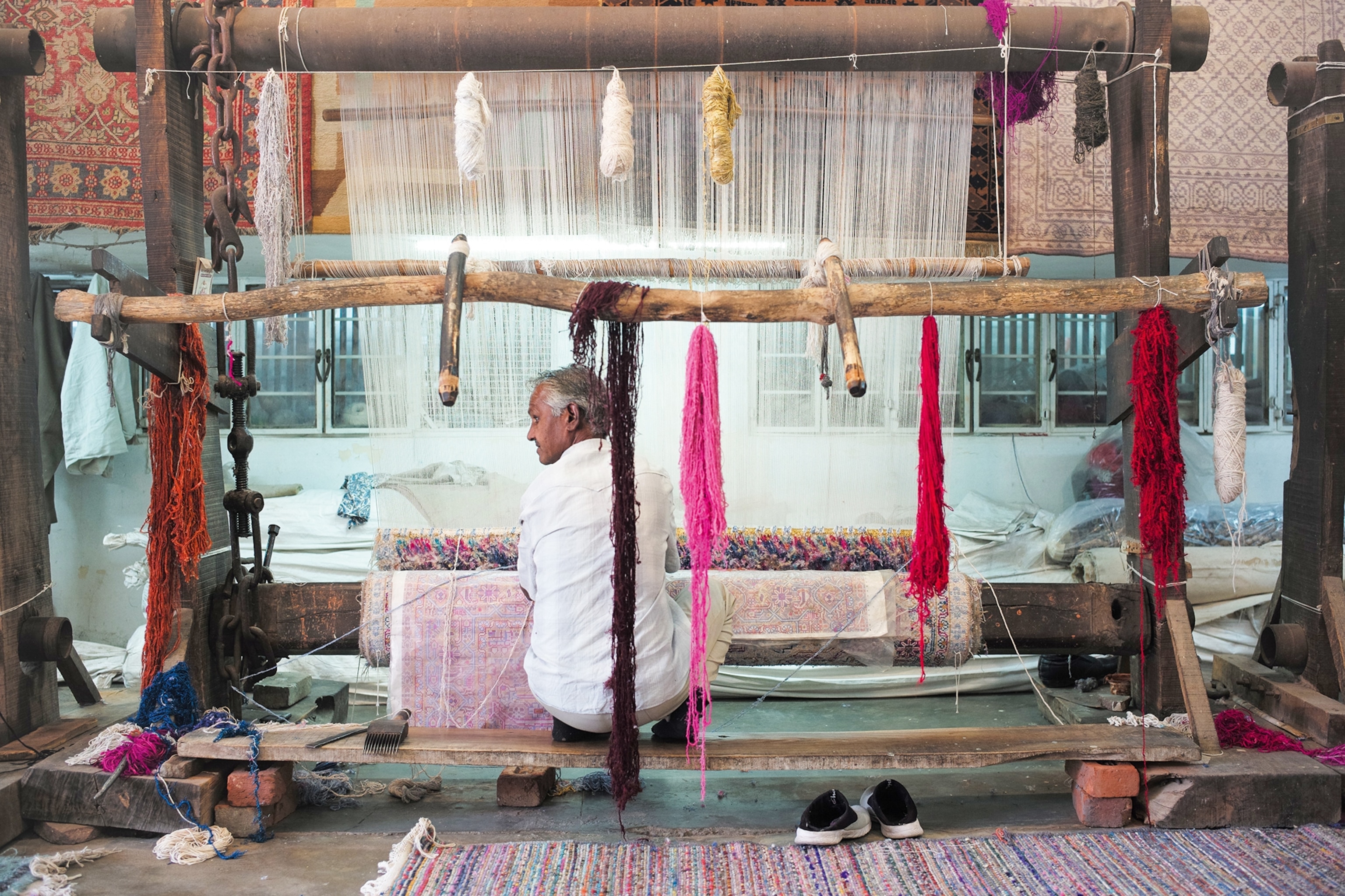 A man weaving.