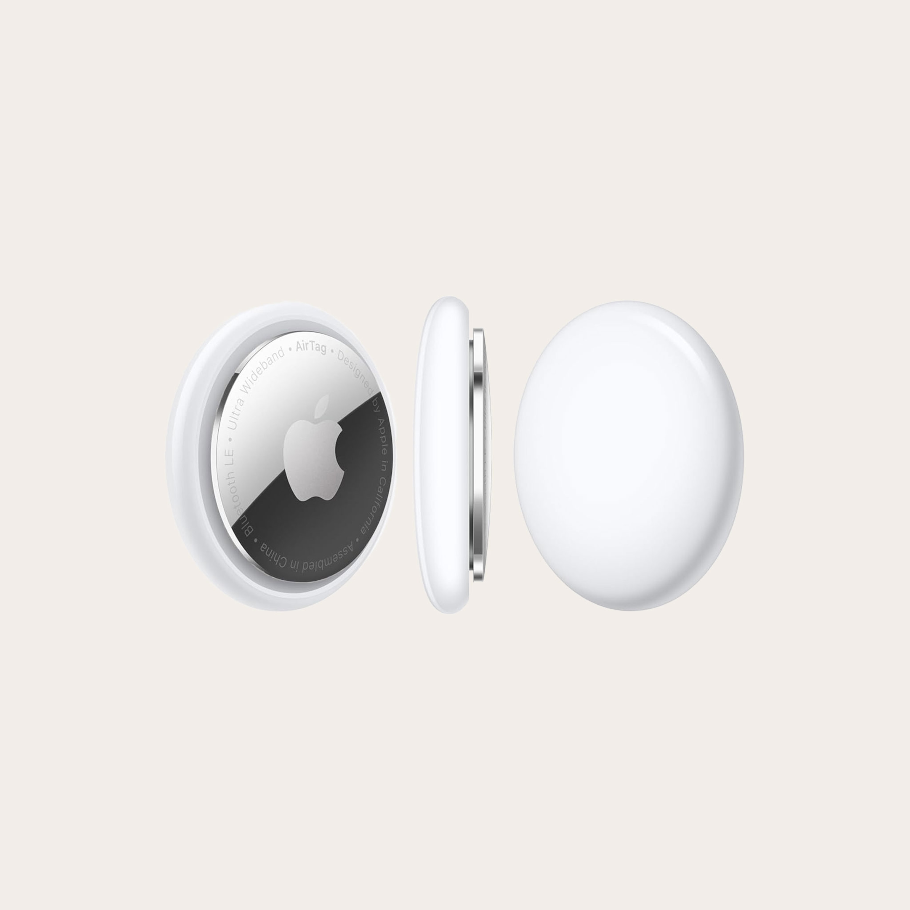 Three white and silver round location tracker devices