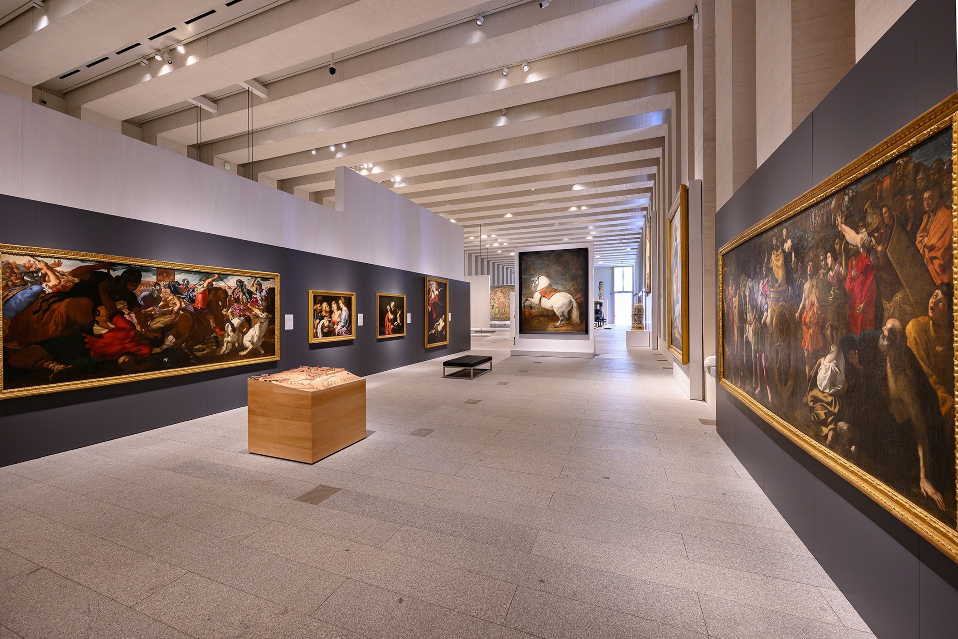 A wall of paintings inside The Royal Collections Gallery.