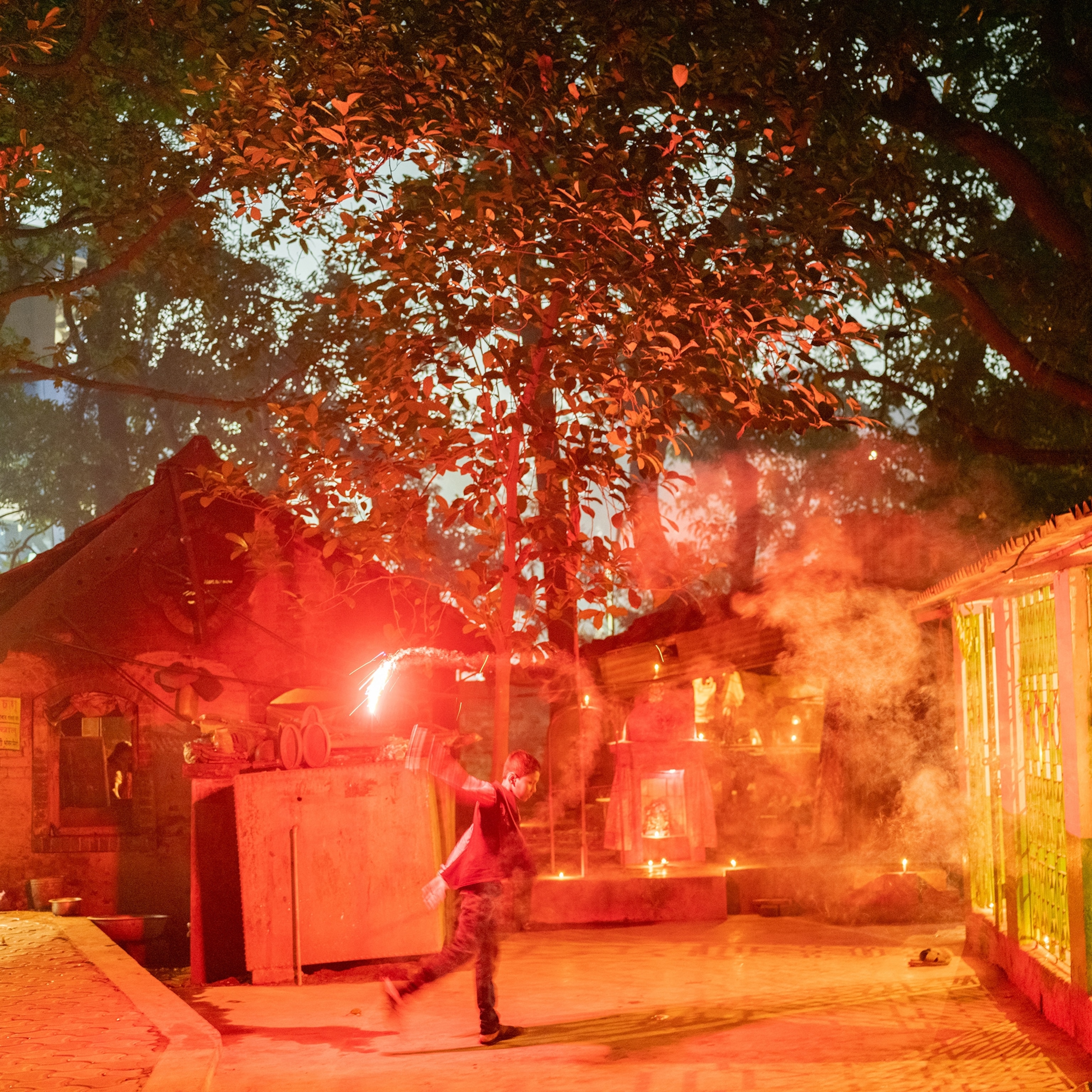 A boy plays with fire crackers during the Diwali celebrations.