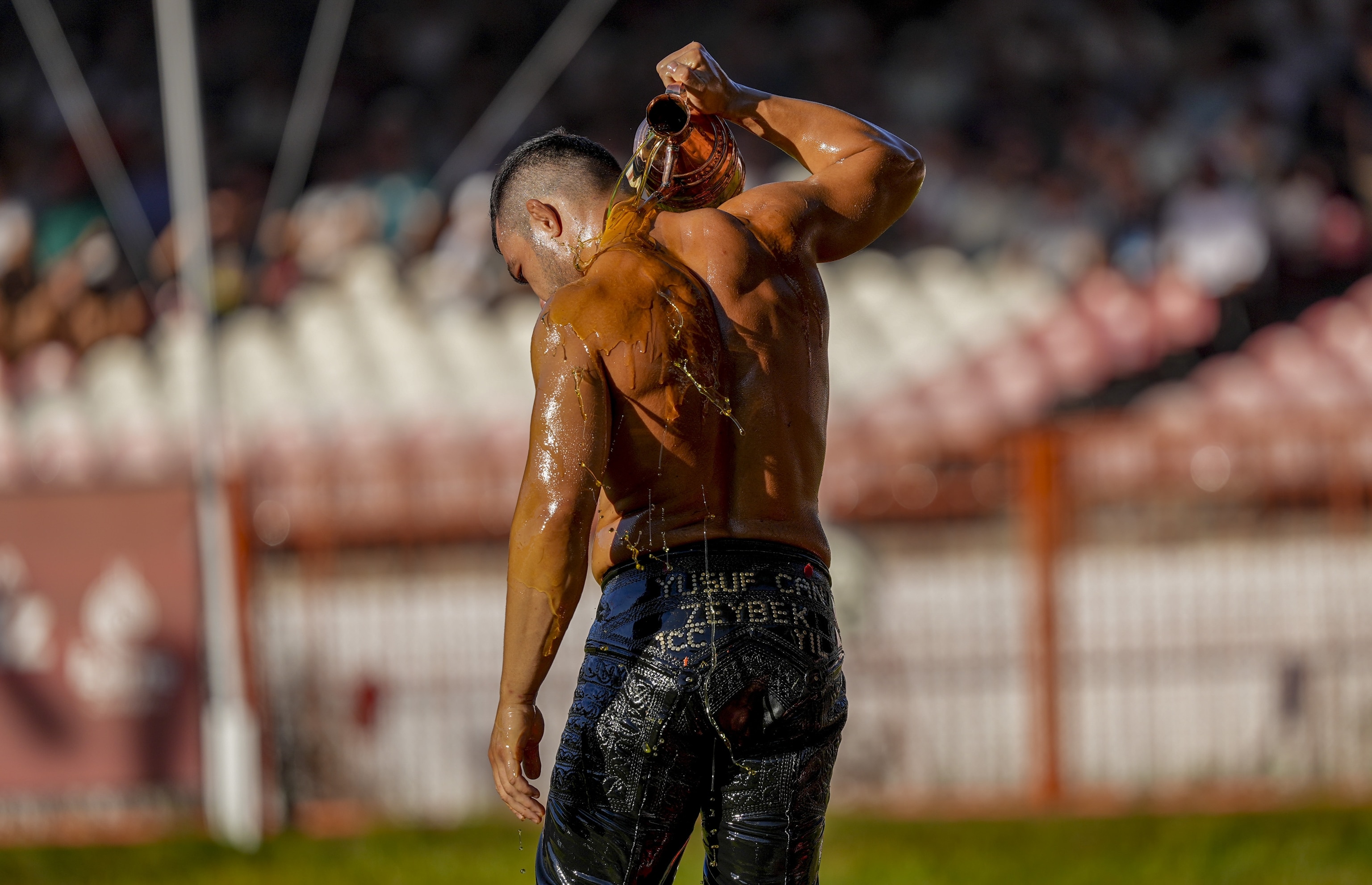 Oil wrestler getting oiled