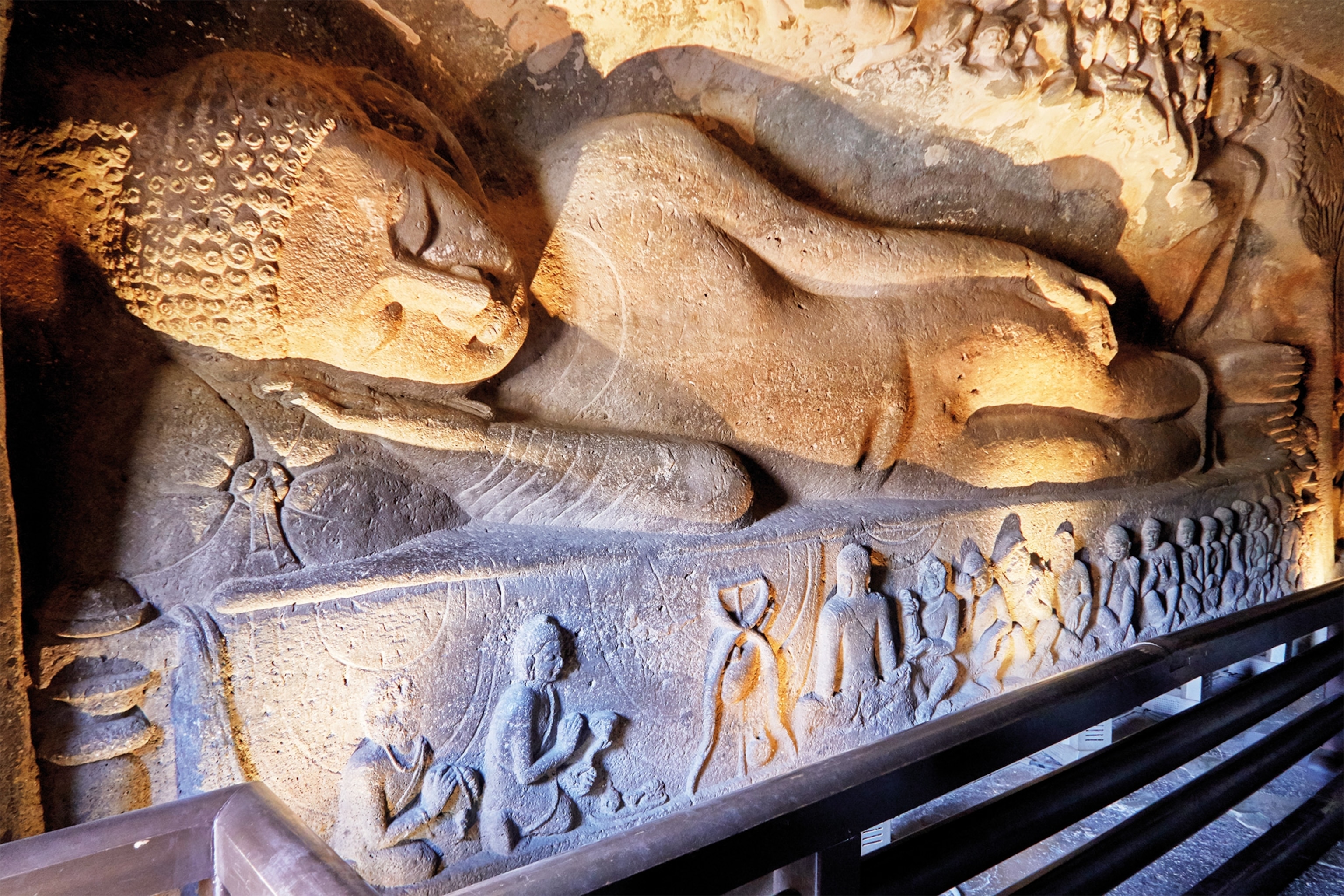 Sculpted in the late fifth or early sixth century, a reclining Buddha is one of the richly detailed sculptures adorning Cave 26 in Ajanta.