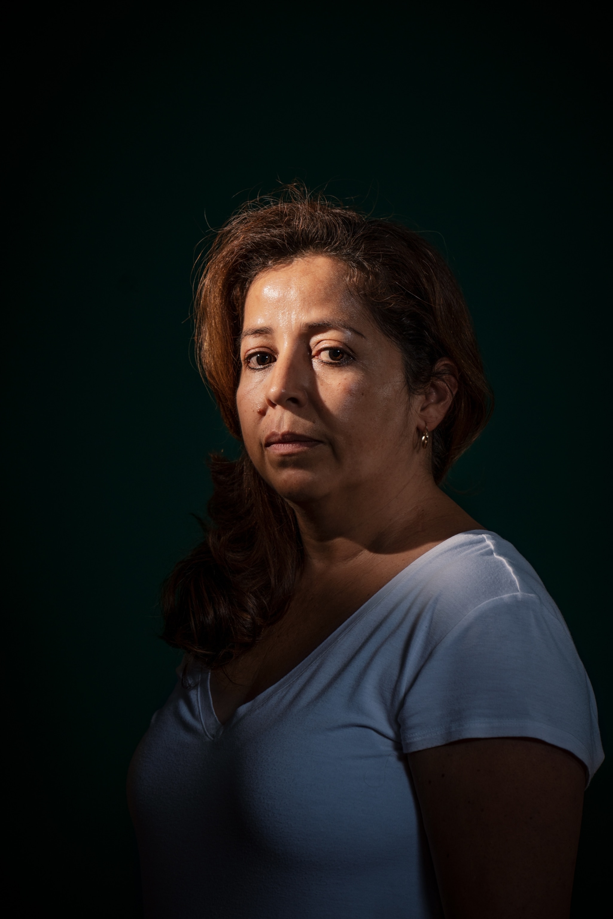 a woman dimly lit