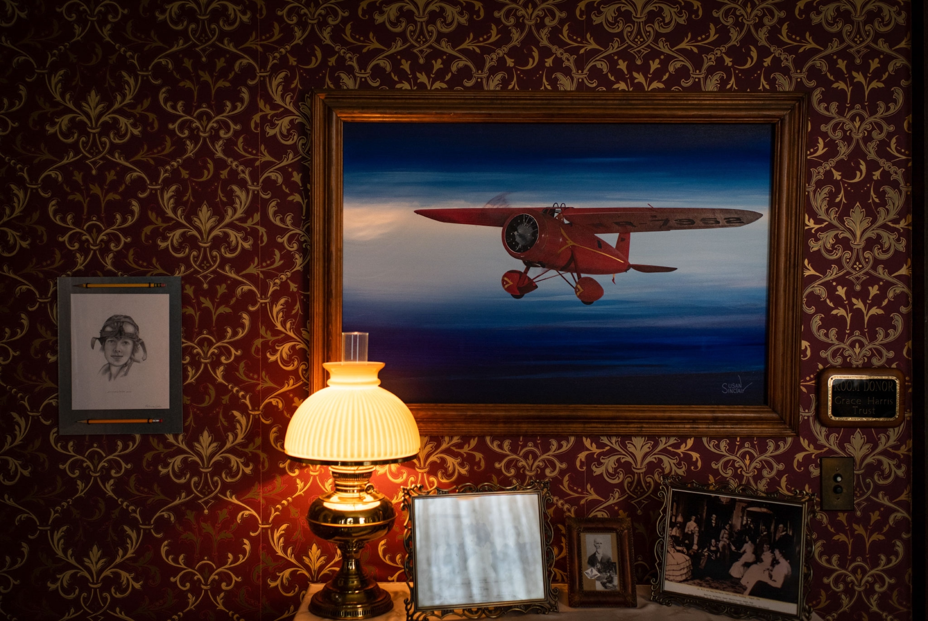paintings of Amelia Earhart and her plane in her birthplace museum