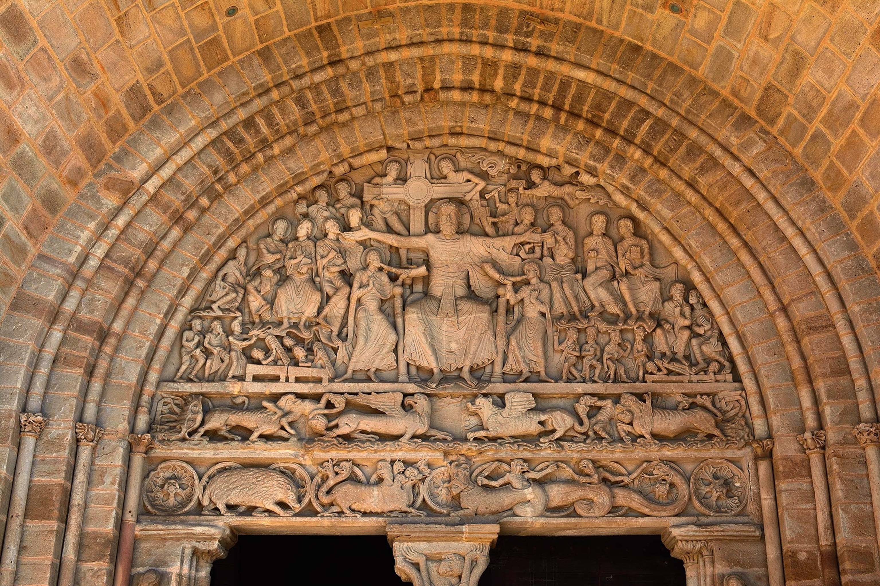 A stone engraving above an entryway at a church features animals