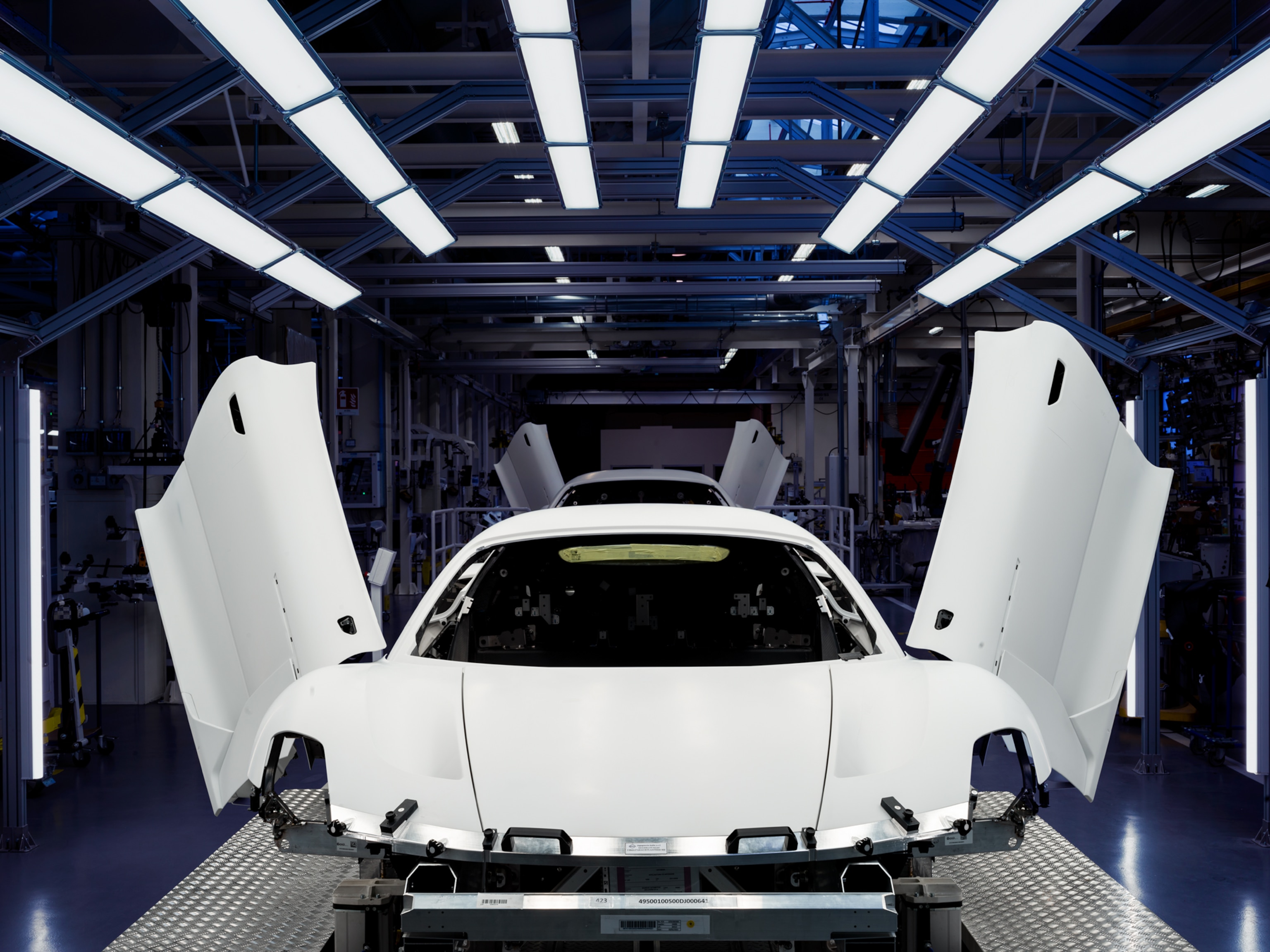 Picture of white car with opened doors looking like wings.