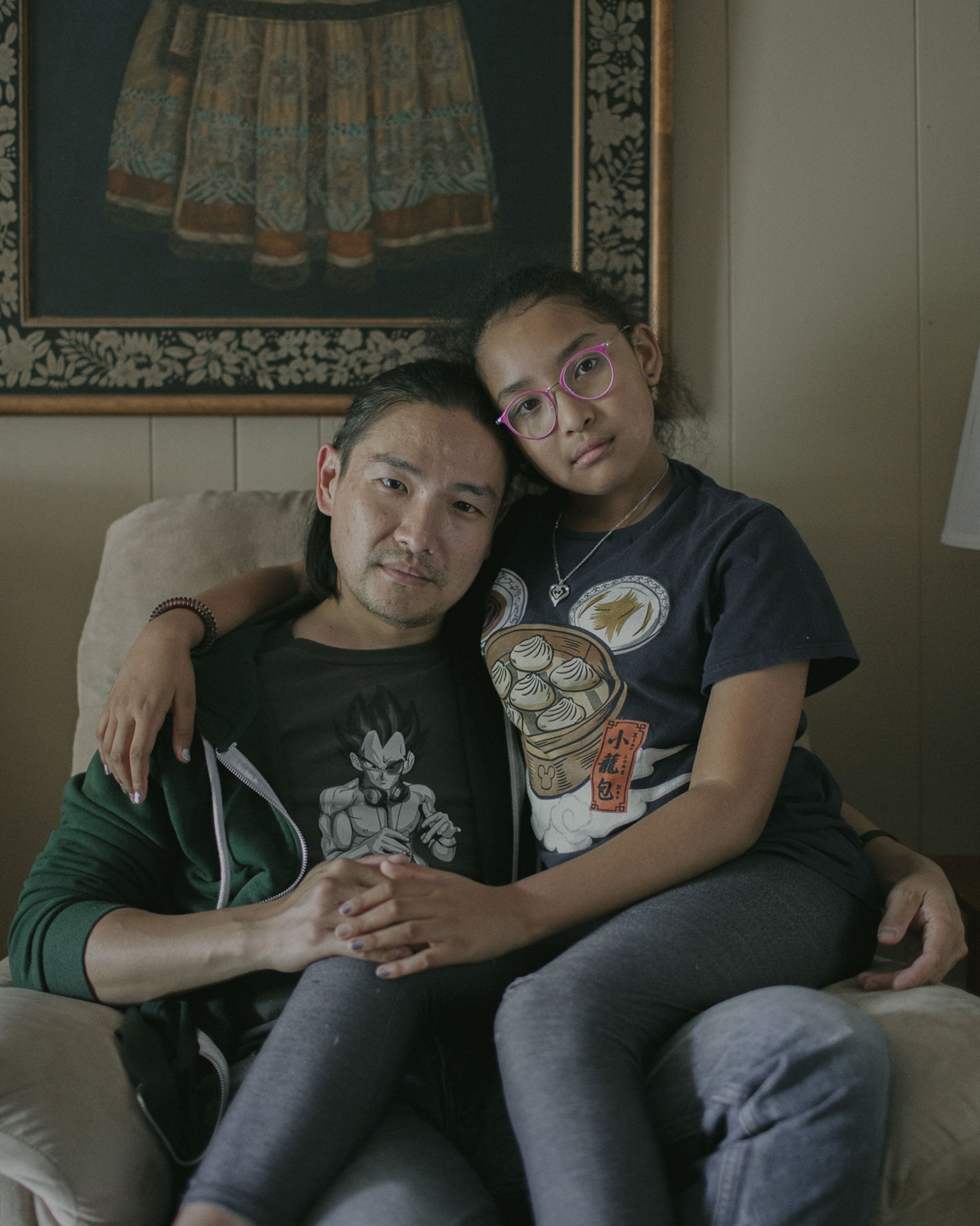a father and his daughter pose for a portrait in their home in Georgia
