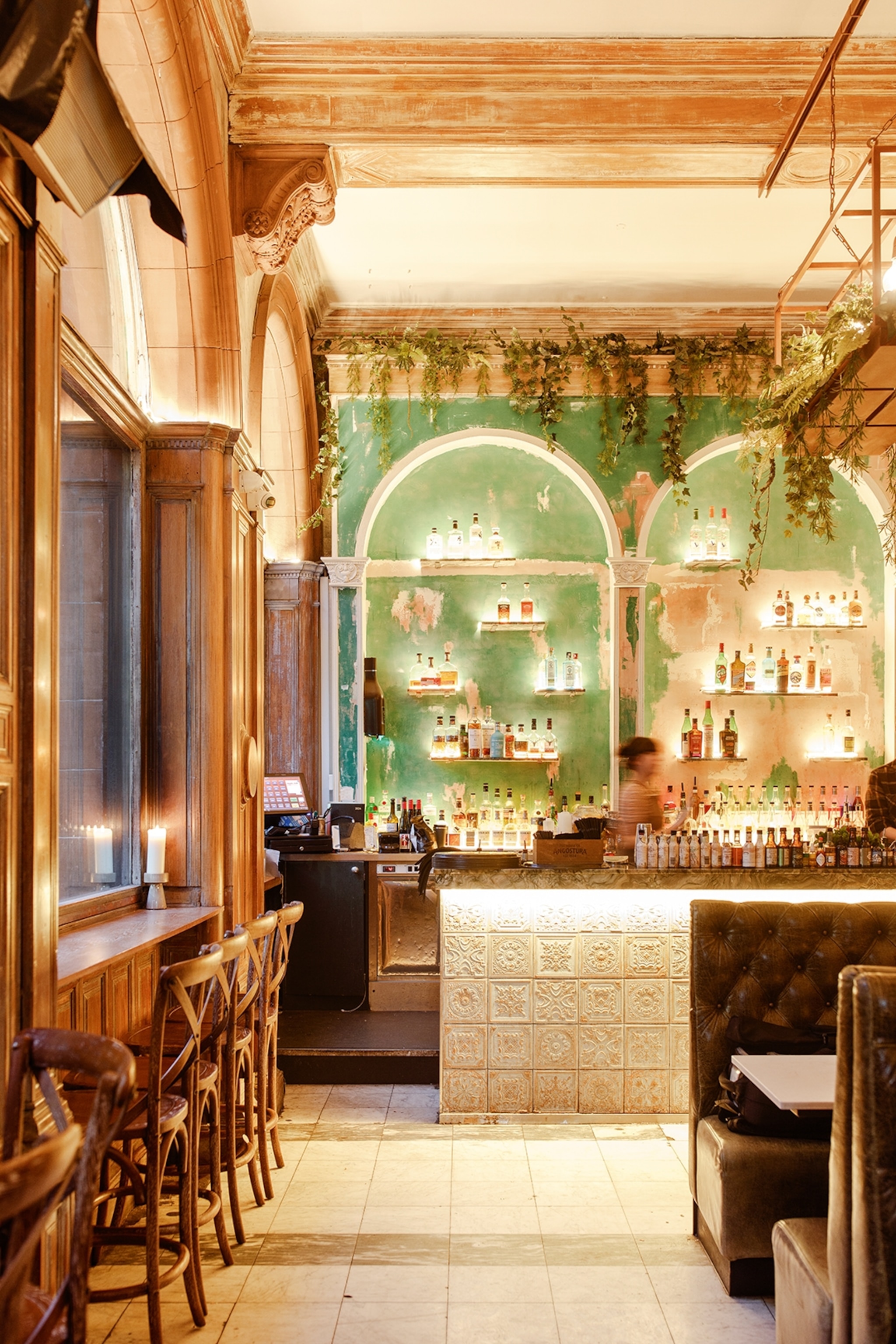 A frescoed, arched bar with a chic, modern design and tall ceilings.