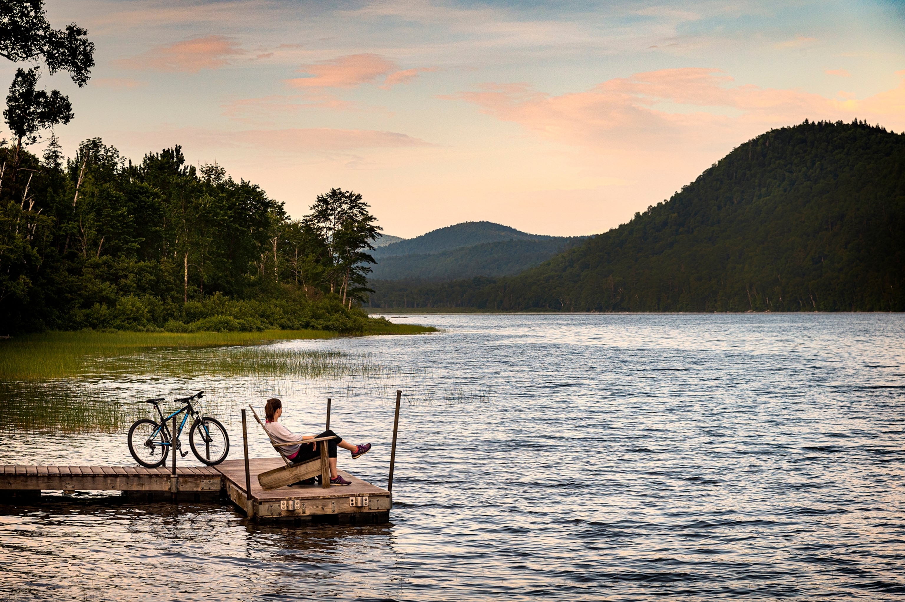 United States of America, New York State, Adirondacks, close to Lake Placid, woman sitting in chair, nature, landscape, overview, mountains, moody, outdoor, relaxing