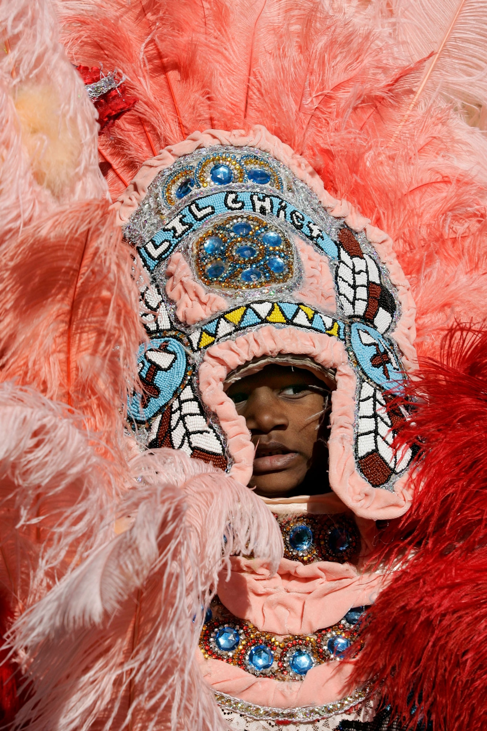 Lil Chief Dwayne Washington, 5, of the Cheyenne Mardi Gras Indian tribe, marches in the Central City neighborhood of New Orleans