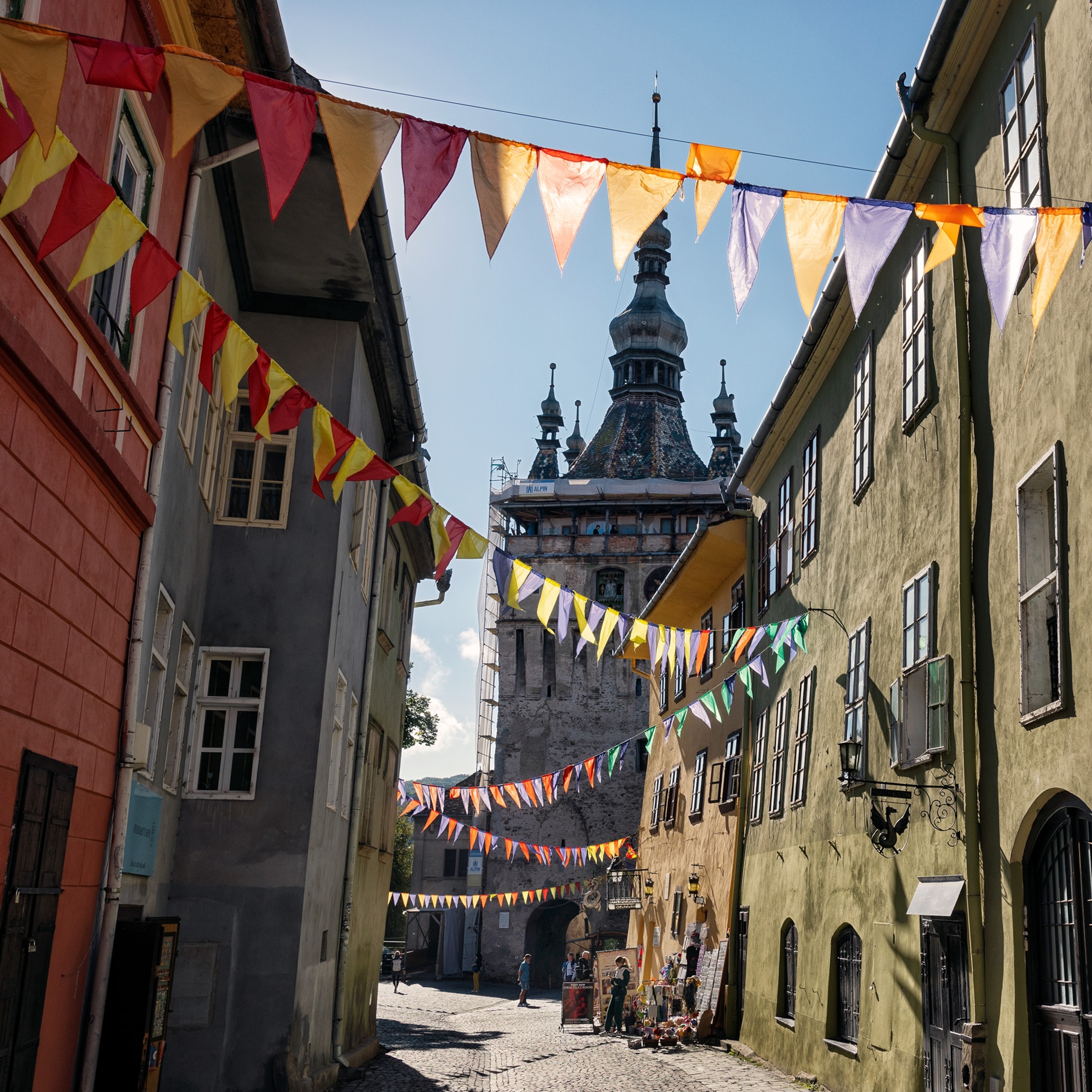 Colorful flags fly above the streets in the historic centre of Sighişoara.