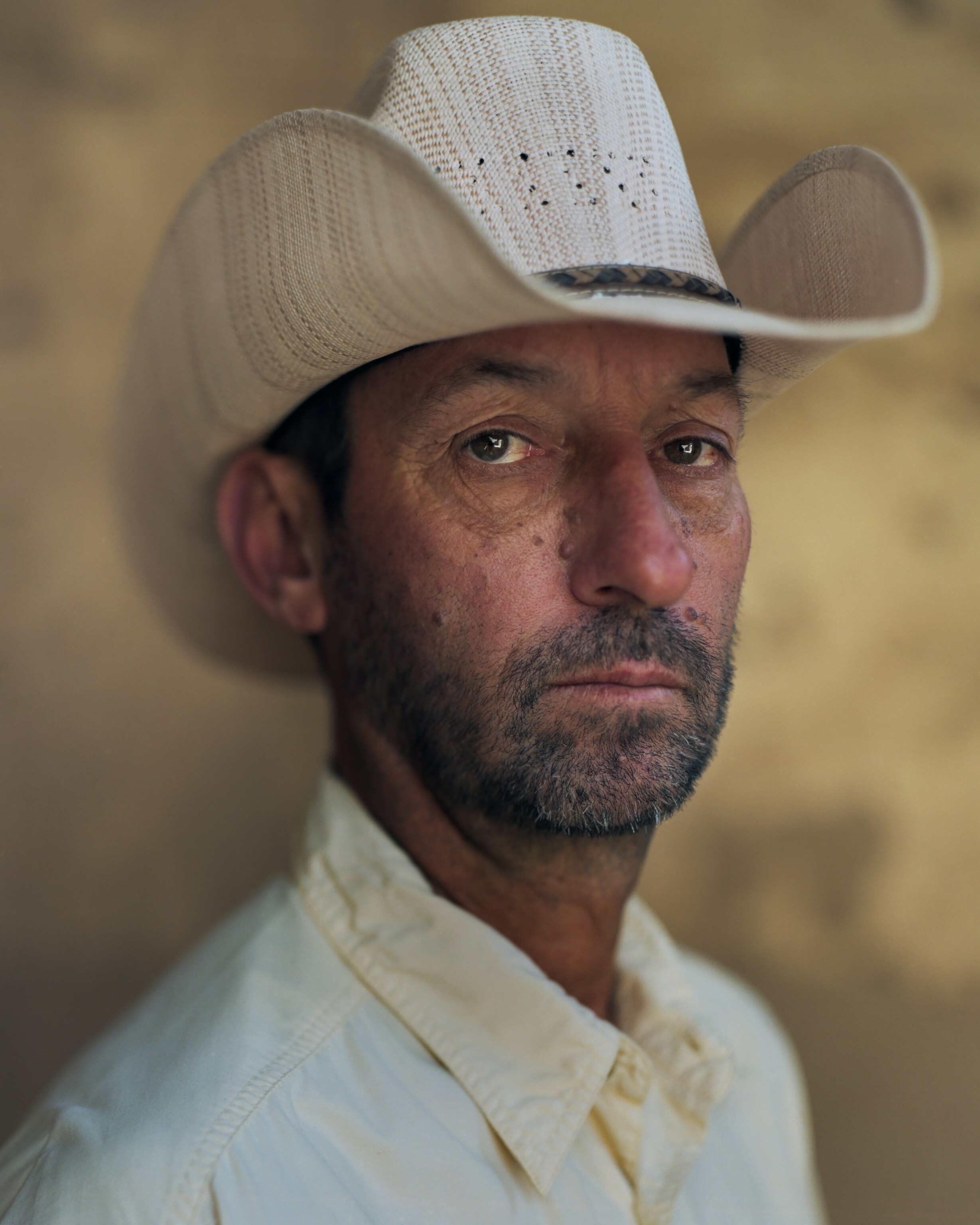 Picture of man with beard in white hat.