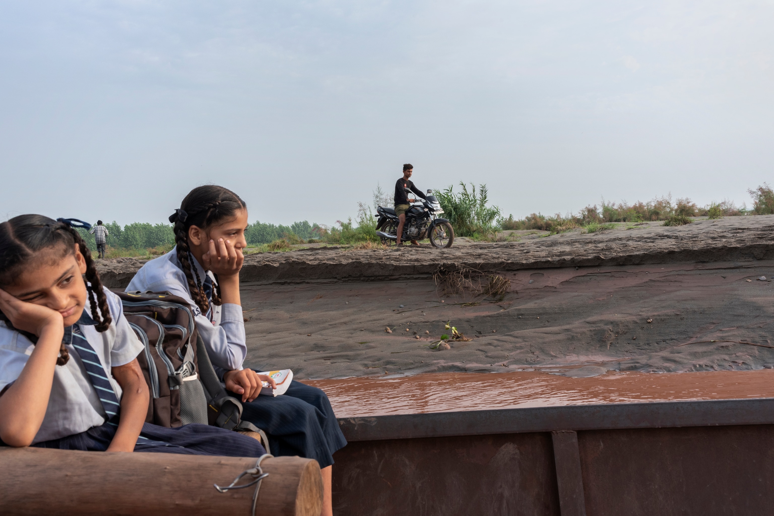 Two sisters take a boat across a river
