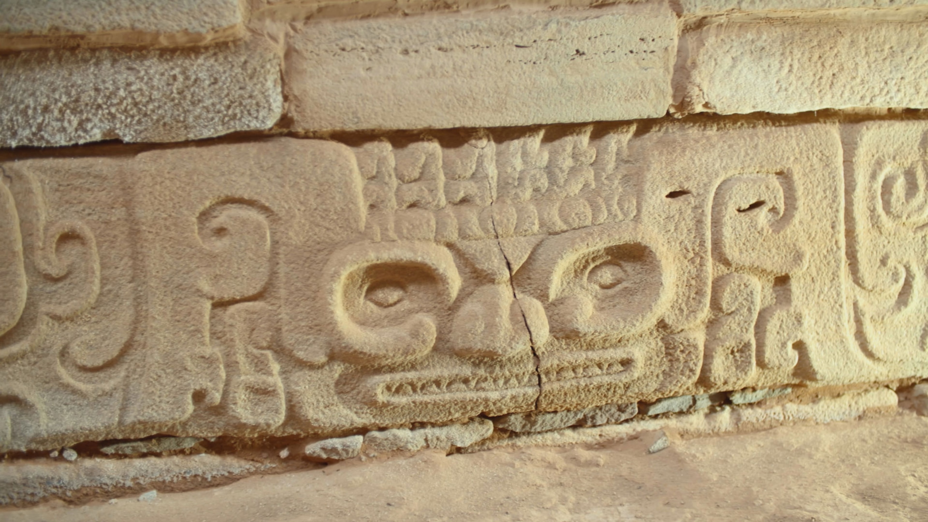 a carved face on a brick