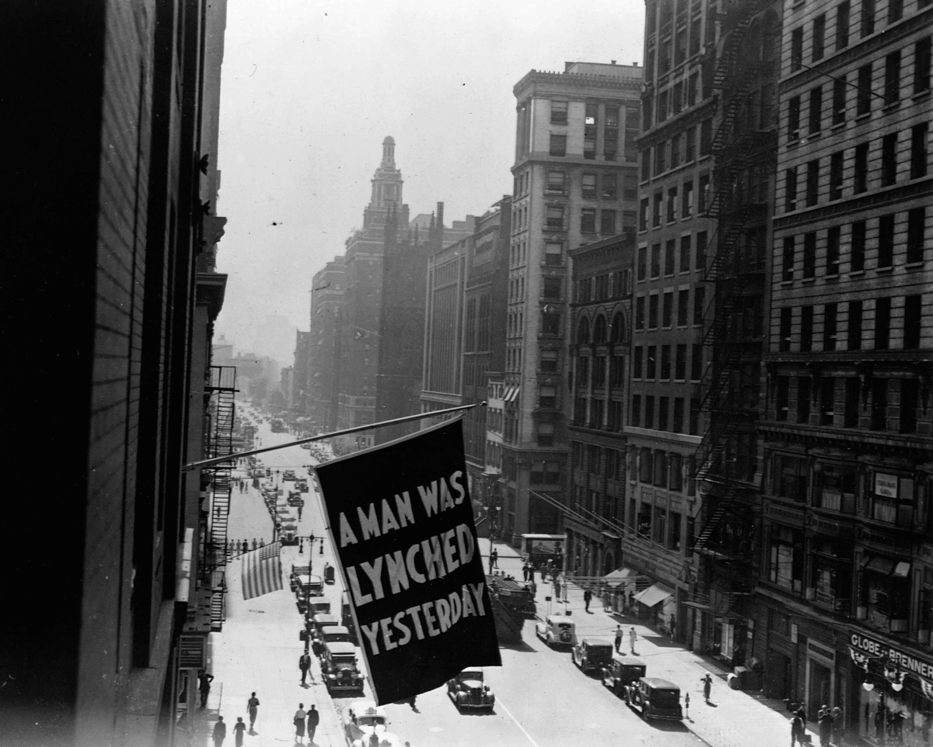 a banner hanging in New York City that says a man was lynched yesterday