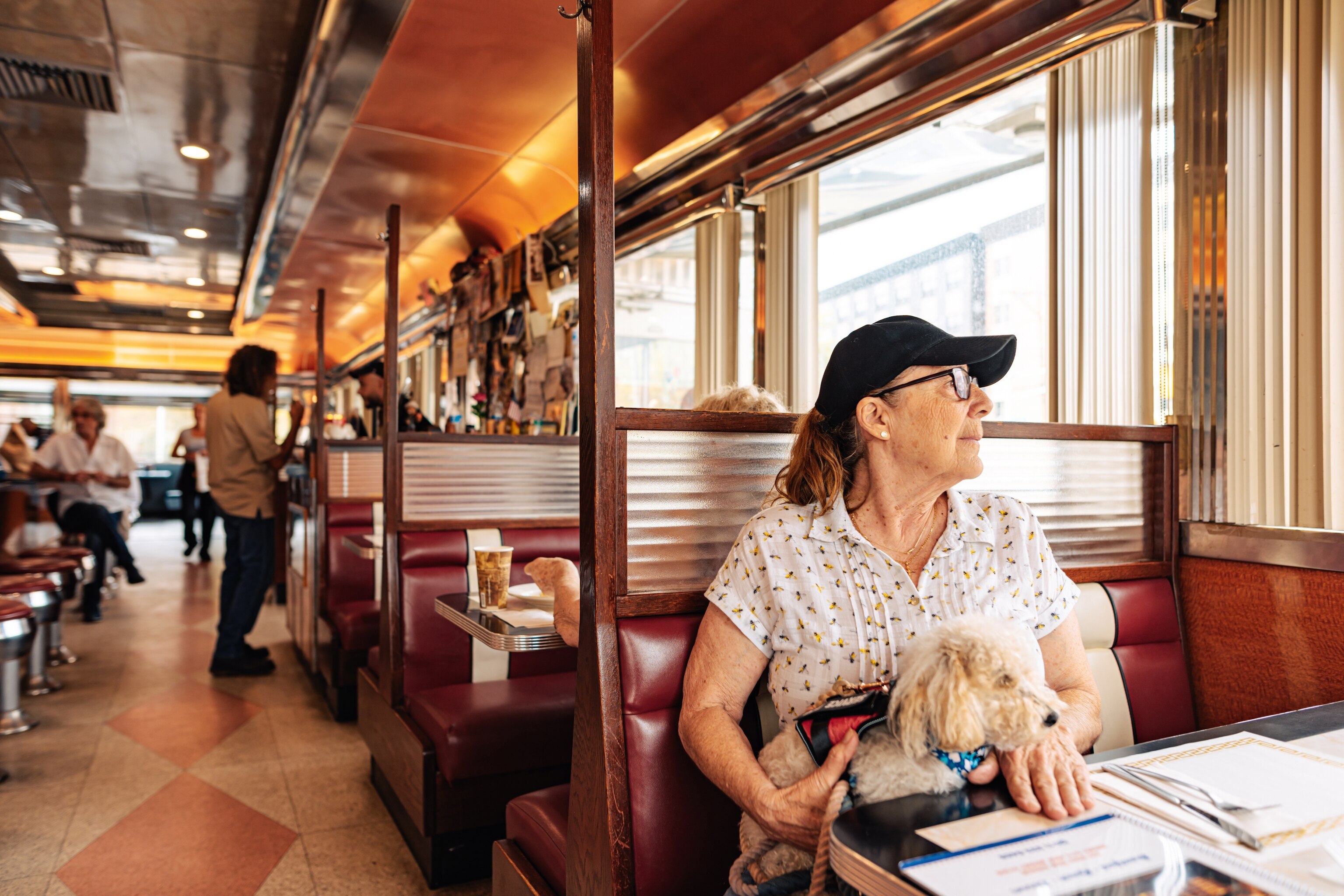 woman with dog in diner