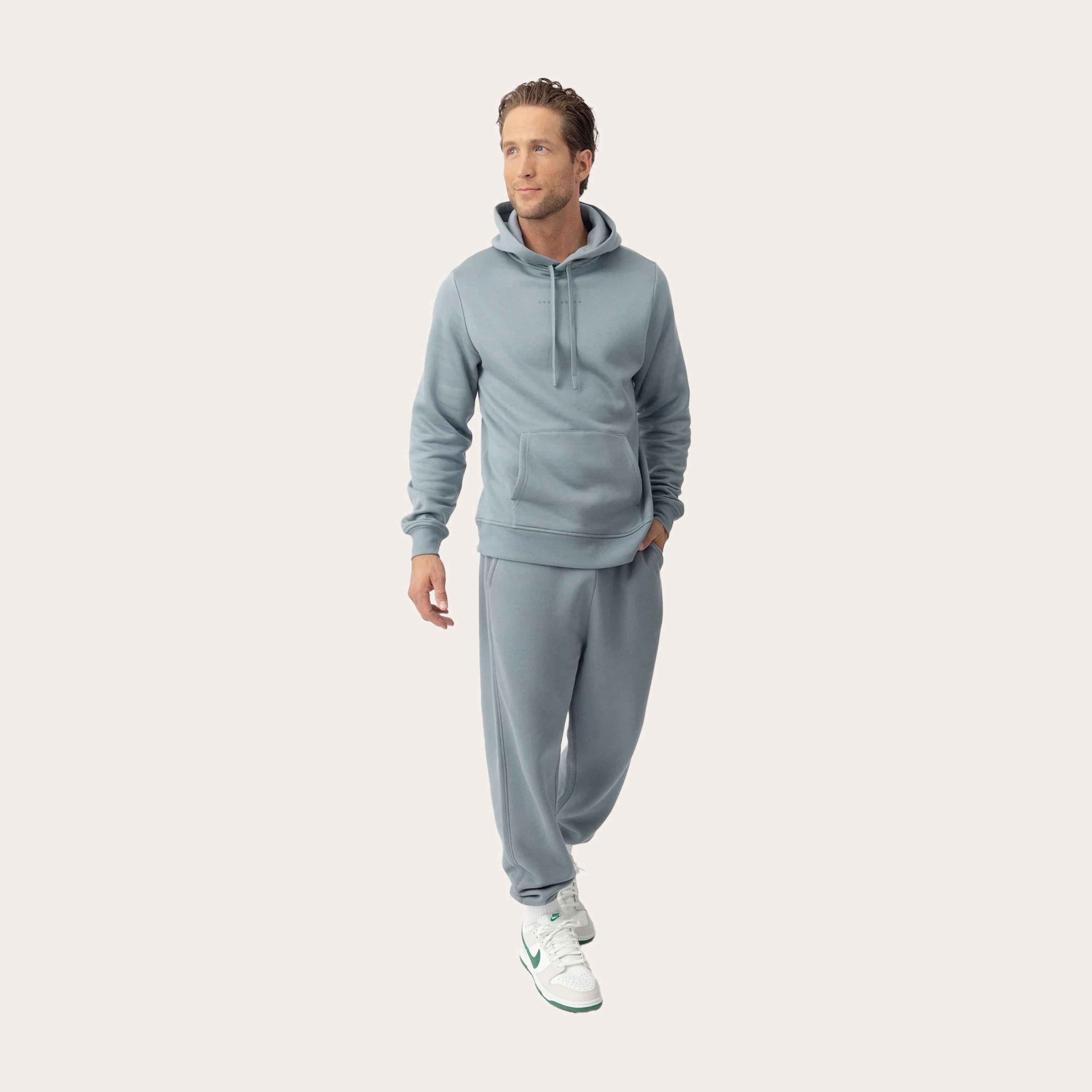Man wearing grey sweatpants and sweatshirt